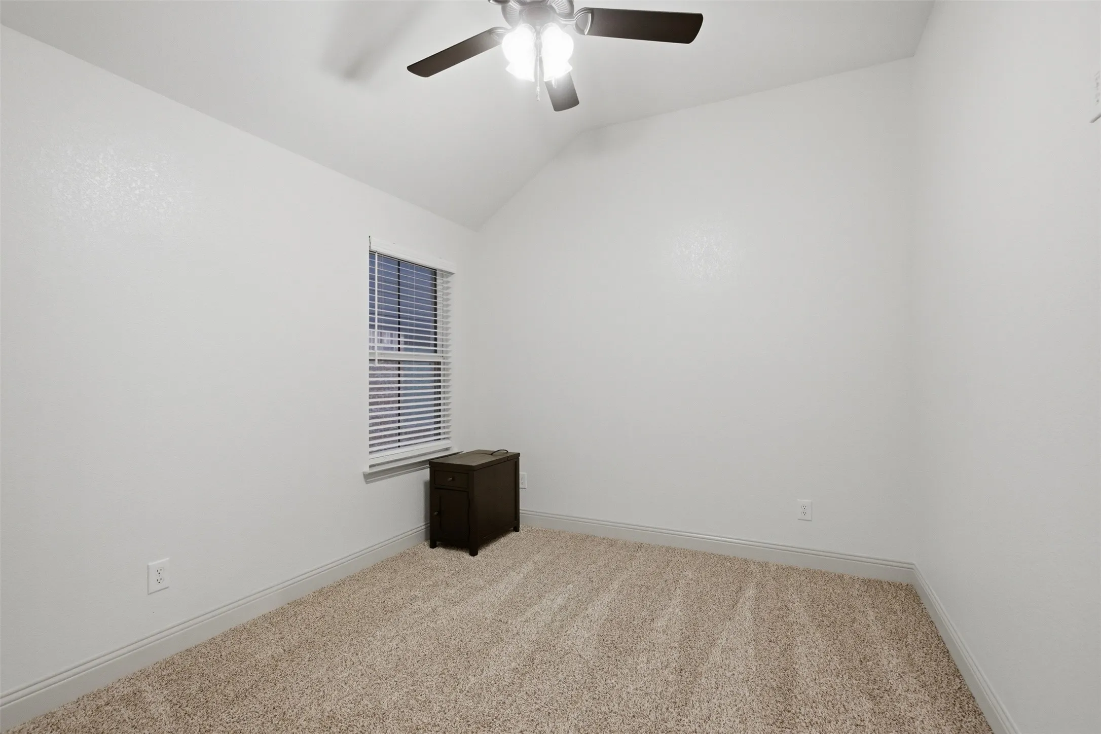 Secondary Bedroom 3, offers plush carpet, ceiling fan