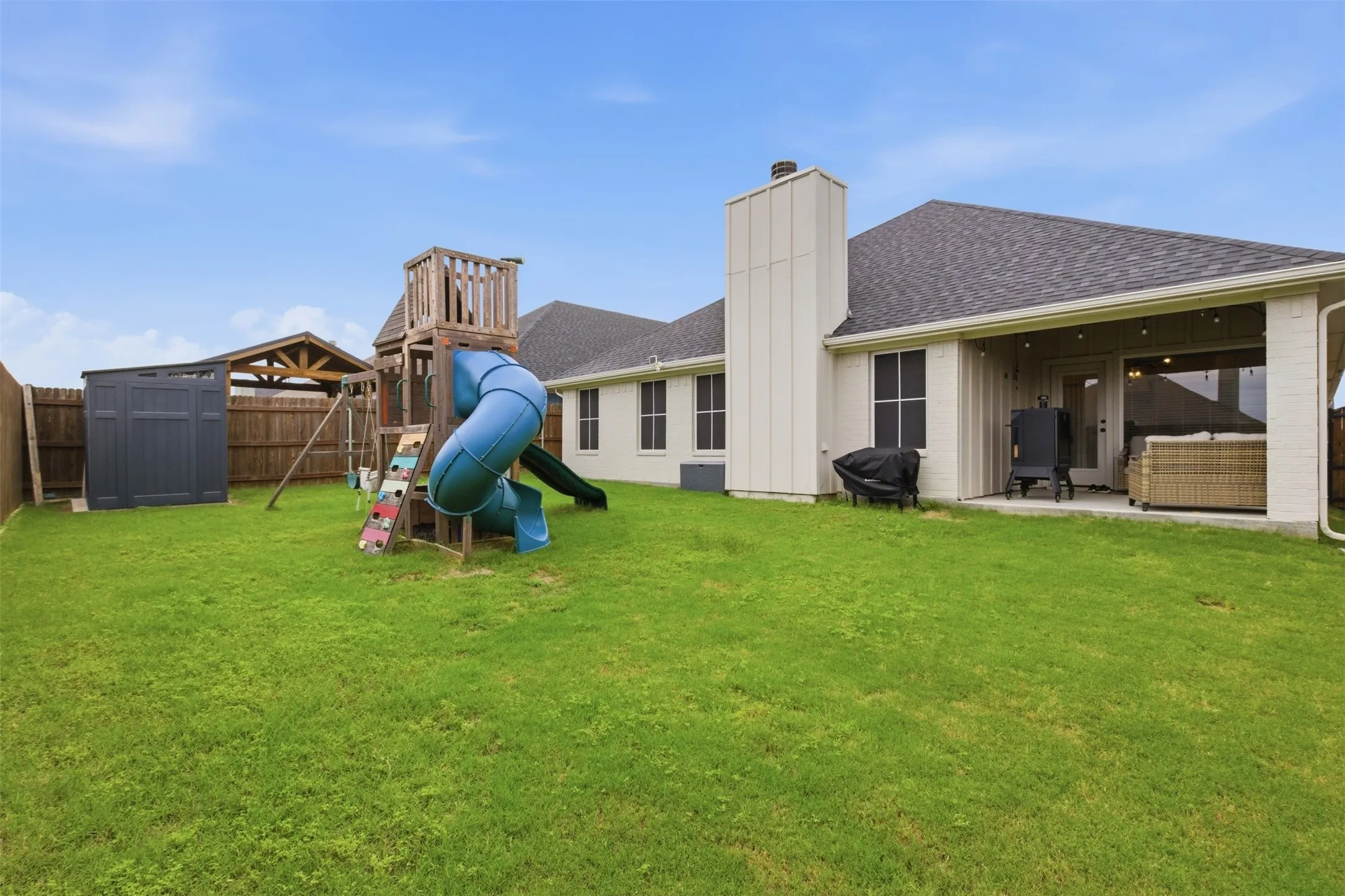 Backyard with partial-owned privacy fence and enough room for backyard entertaining!