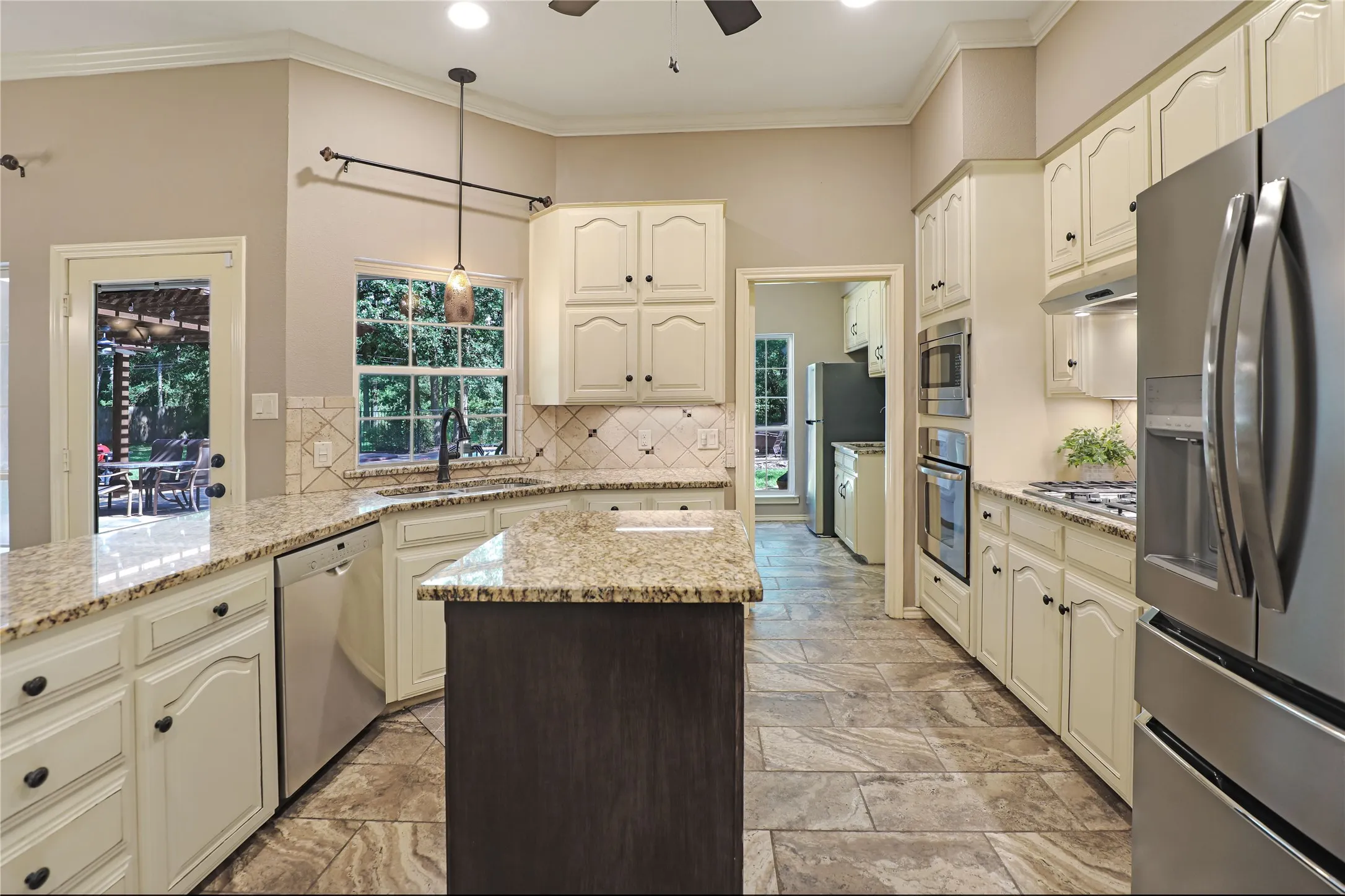 Kitchen with moveable island looking toward laundry room