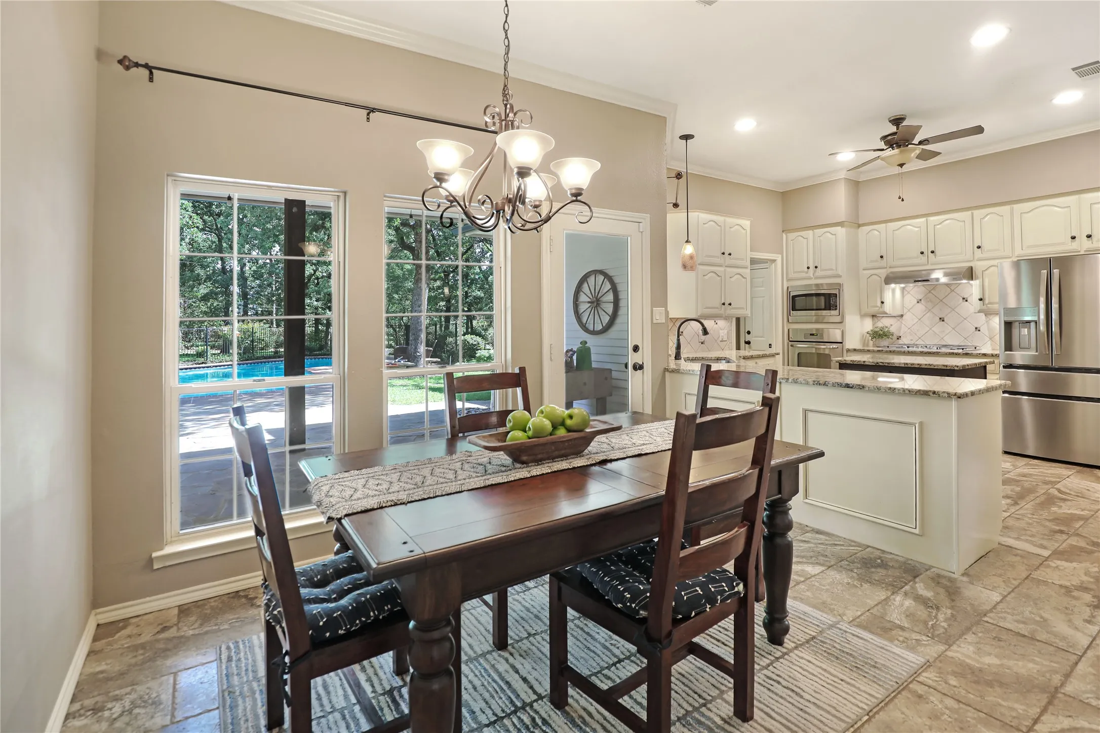 large breakfast area accommodating a full-size table with view of pool