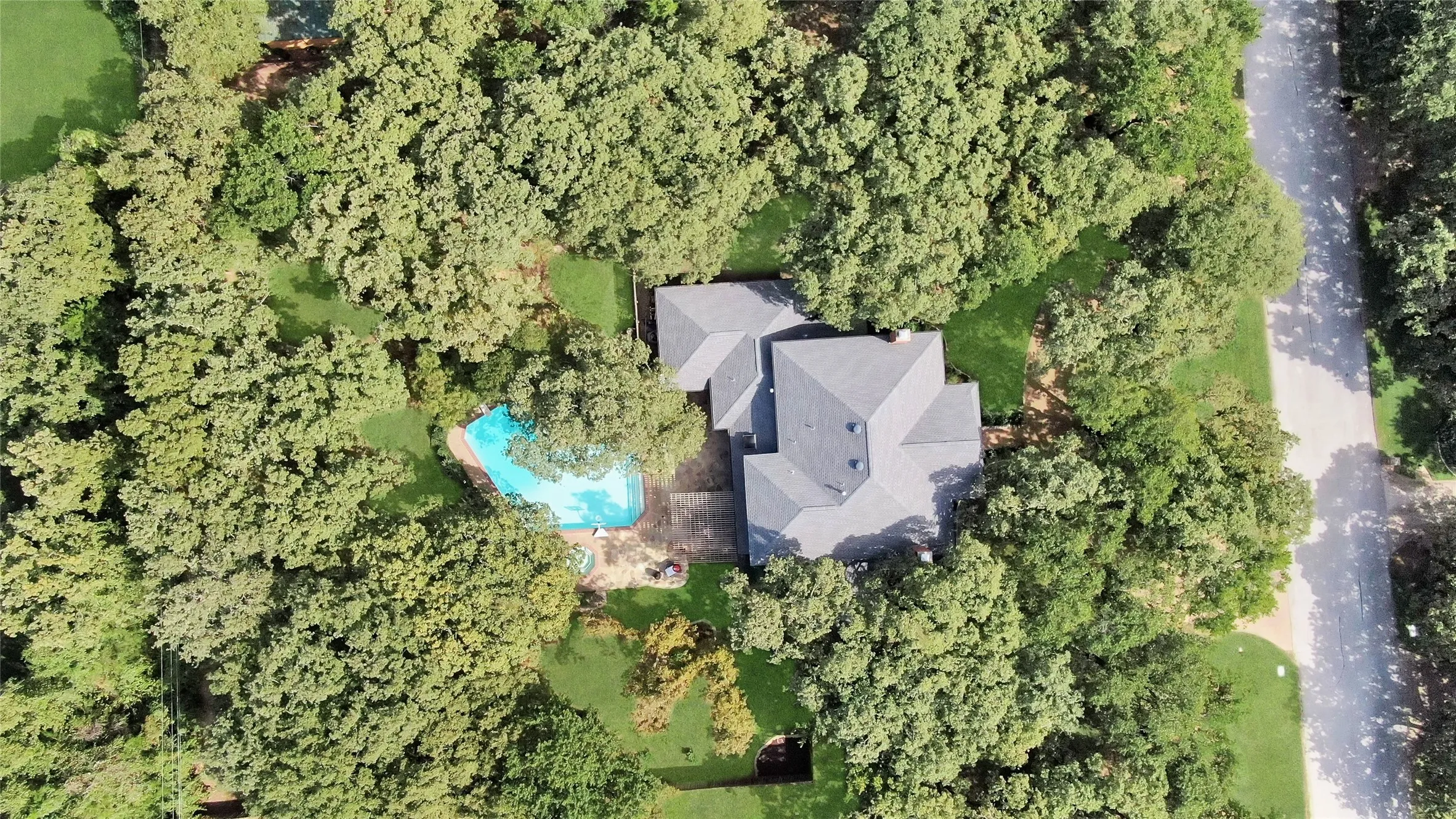 Aerial view of property demonstrating canopy of mature oak trees