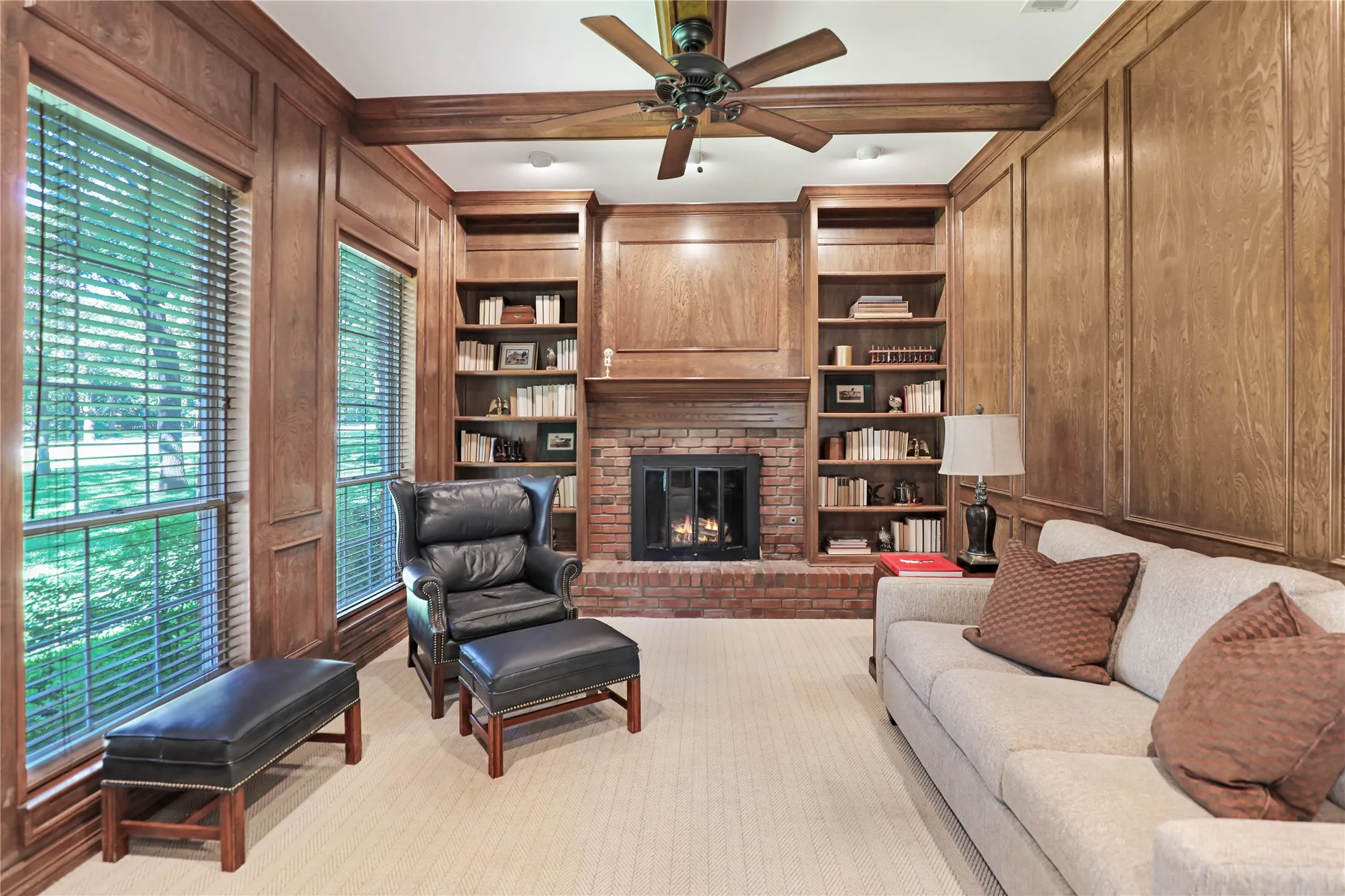 Den with gas lighter wood burning fireplace