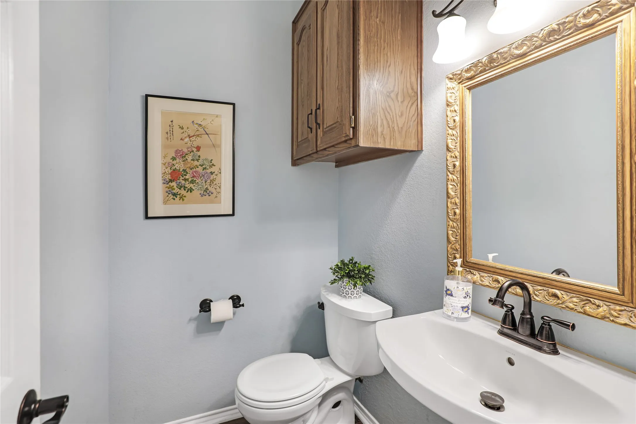 Formal powder bathroom in hallway between kitchen and front entry
