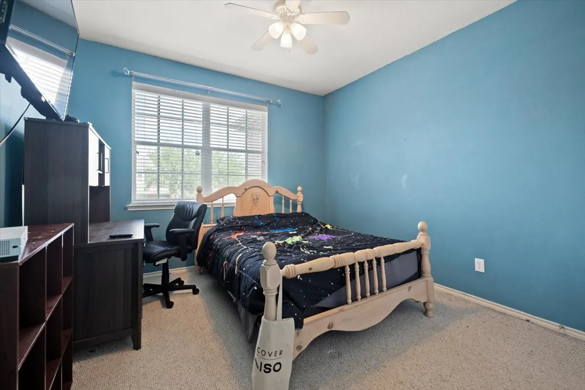 Bedroom featuring light blue walls and neutral carpet