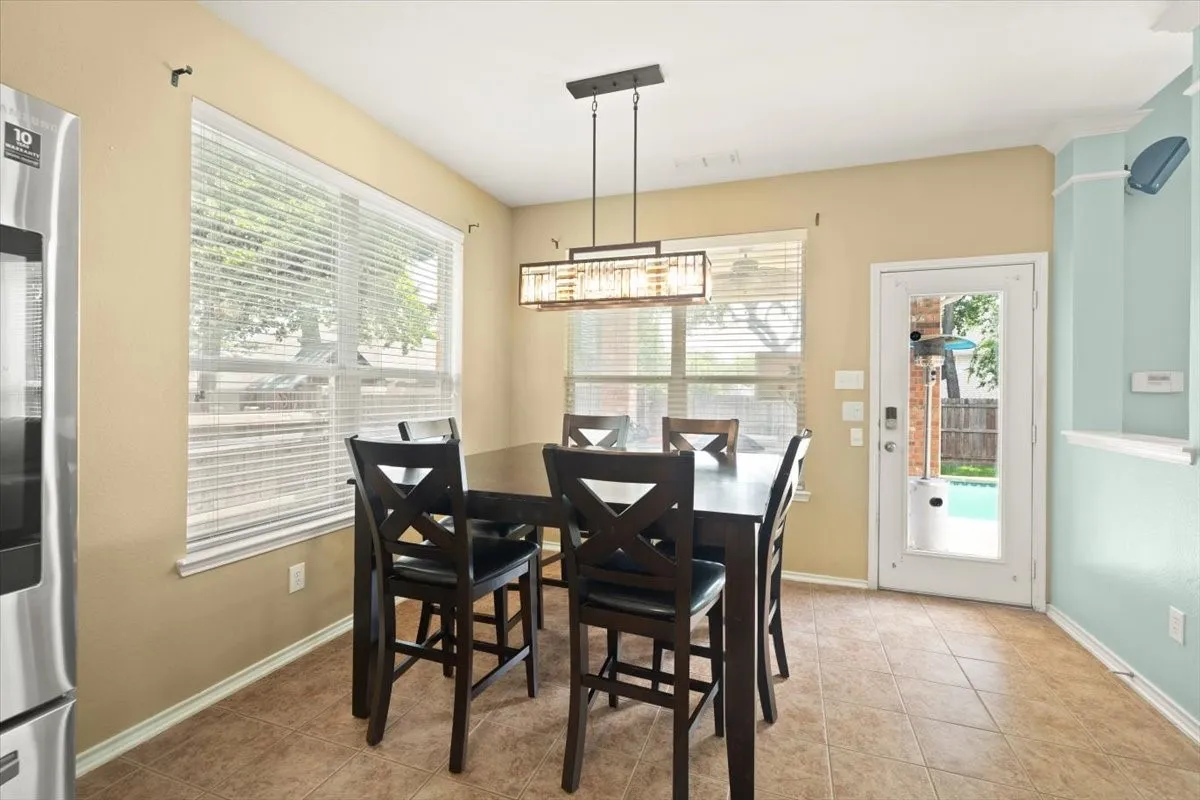 Dining area featuring a modern linear chandelier