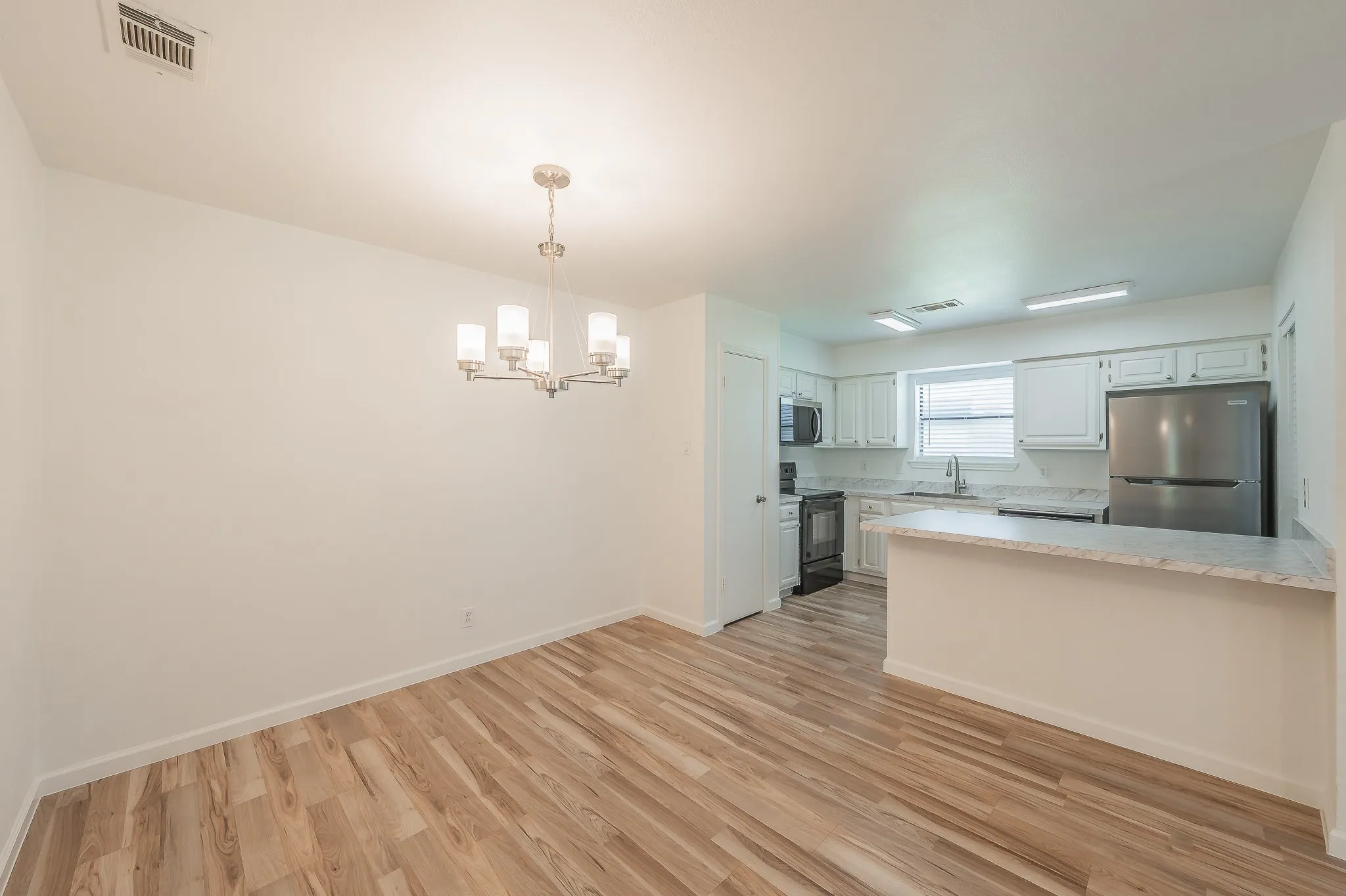Open-concept living space featuring wood-finish flooring