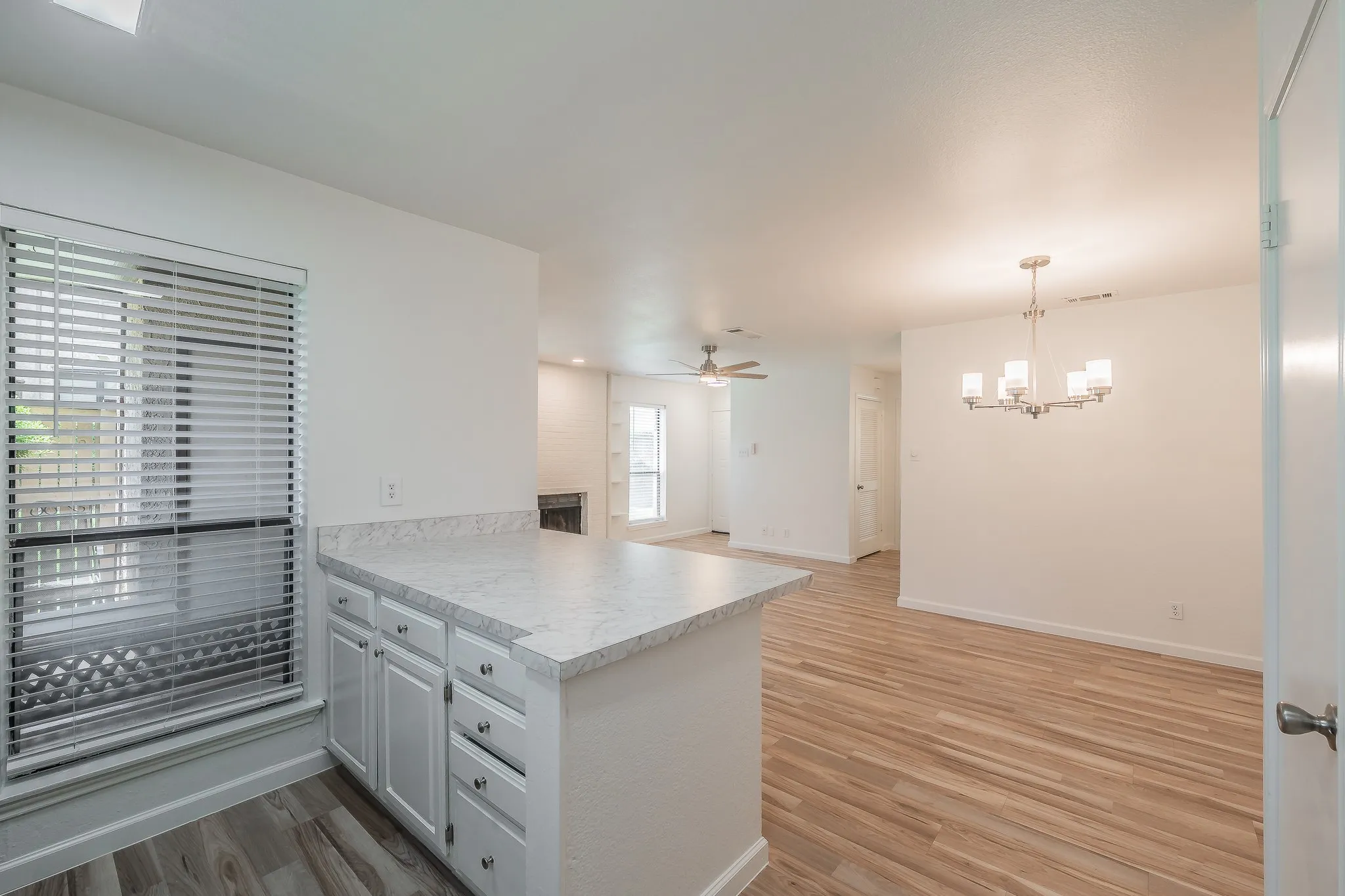 Kitchen island with white cabinetry and a light-toned countertop