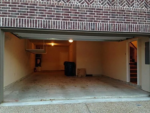 THREE car tandem garage comes with shelving for additional storage.  Good for boat parking, longer vehicles or workshop