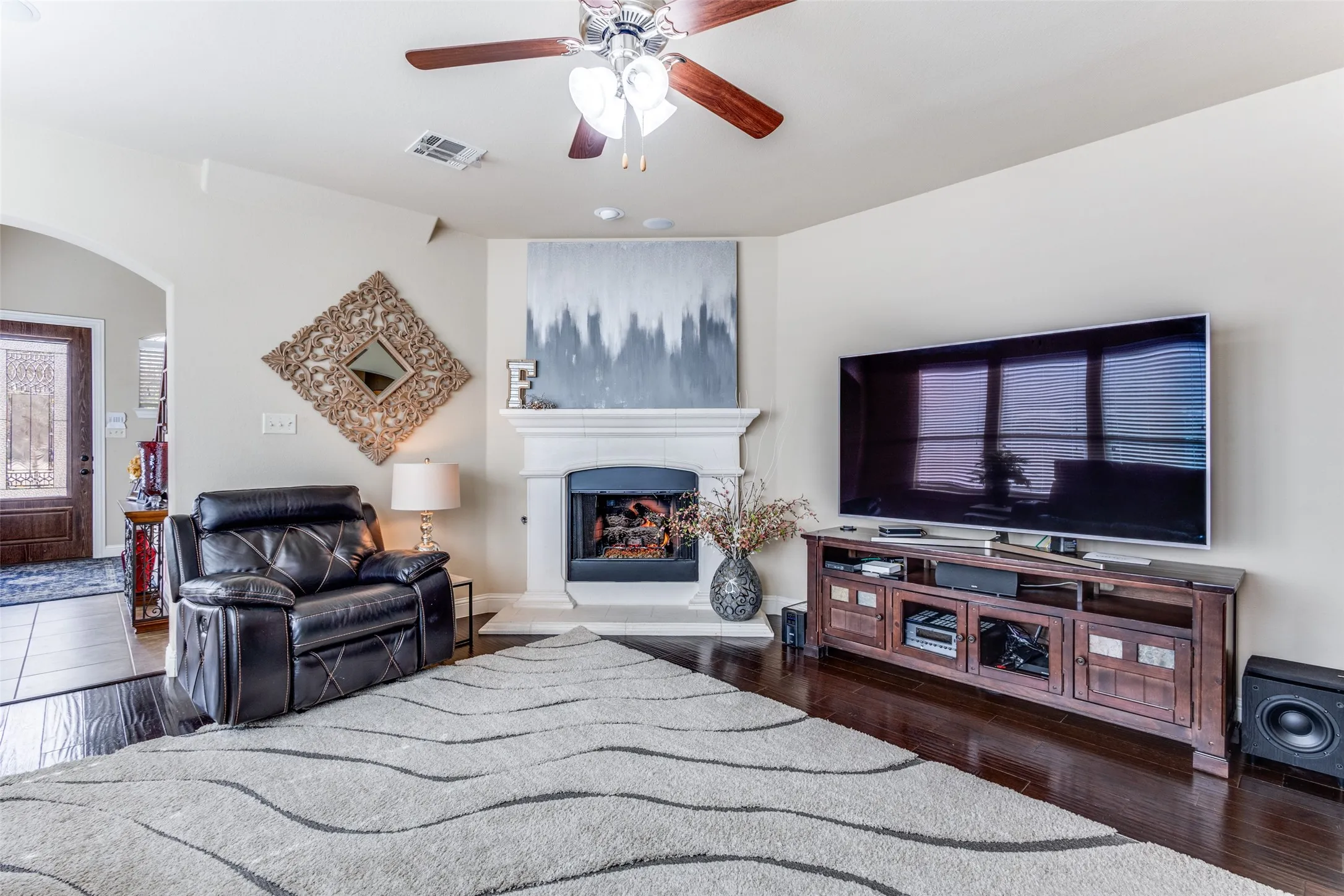 Family Room with wood flooring wall of windows and gas fireplace