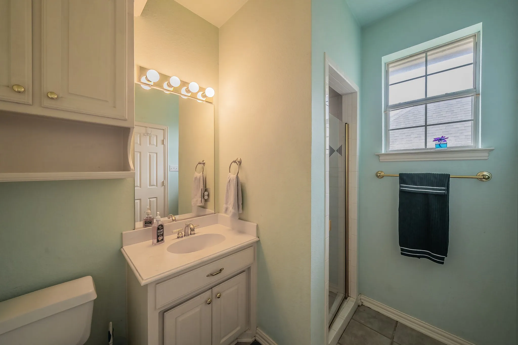 Bathroom attached to Mother in law suite or second owner's suite with private access to covered patio and pool area.