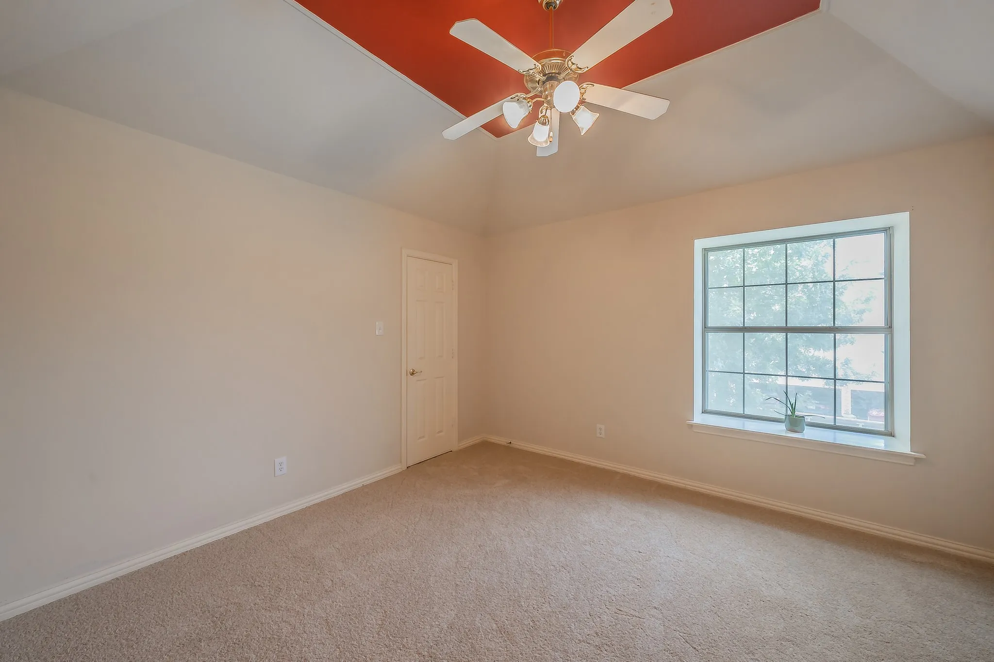Secondary bedroom with newly installed carpet and fresh paint.