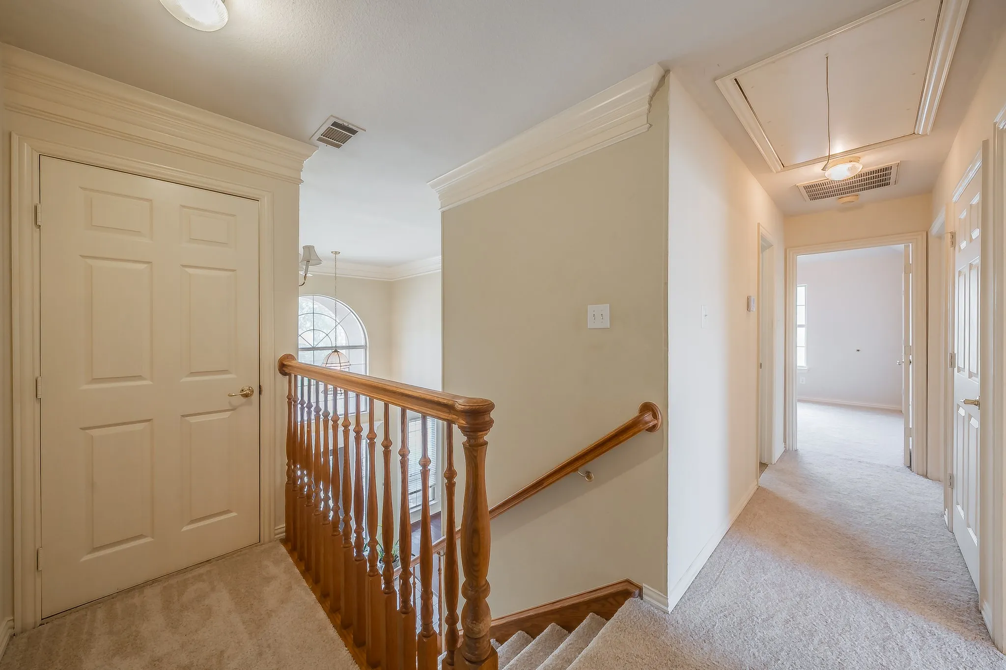 Upstairs hallway leading to bedrooms and downstairs foyer.
