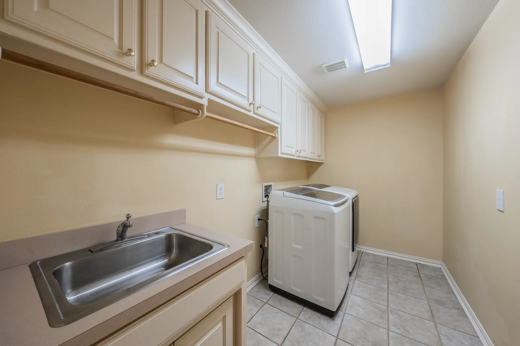 Extra large laundry room with space for a refrigerator.