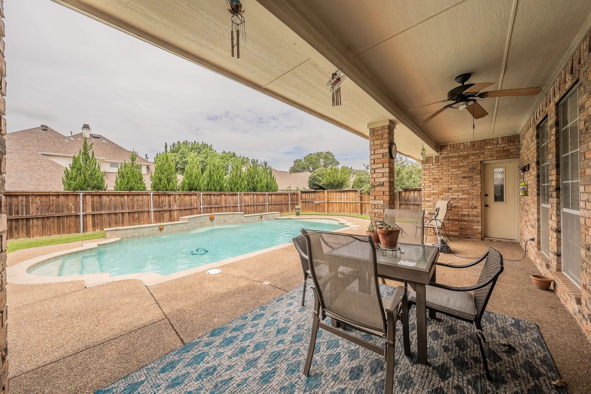 Covered patio extends across the back of the home with a private entrance to the secondary owner's or mother in law suite.