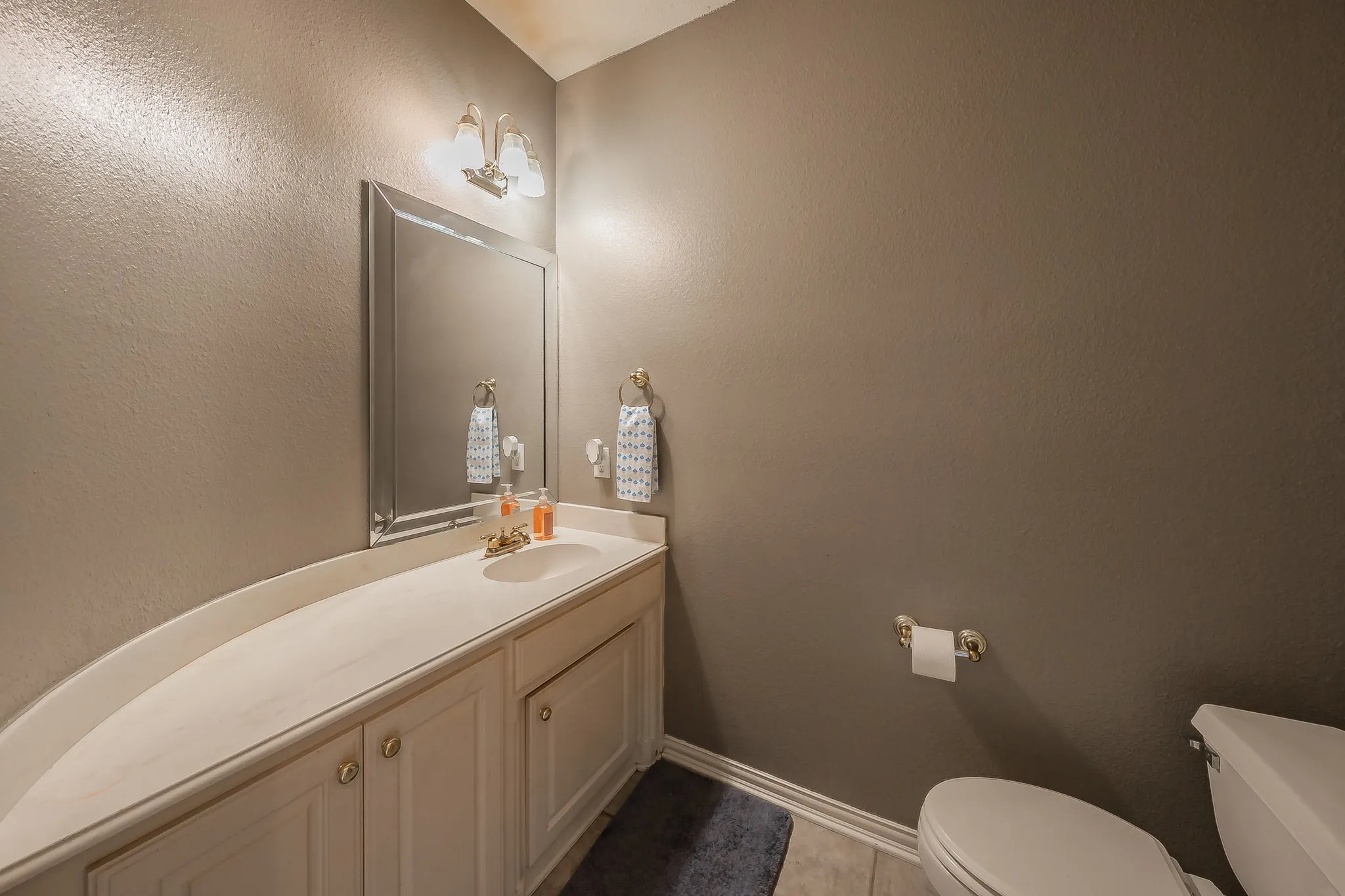 Half bath located off the foyer for your guests.