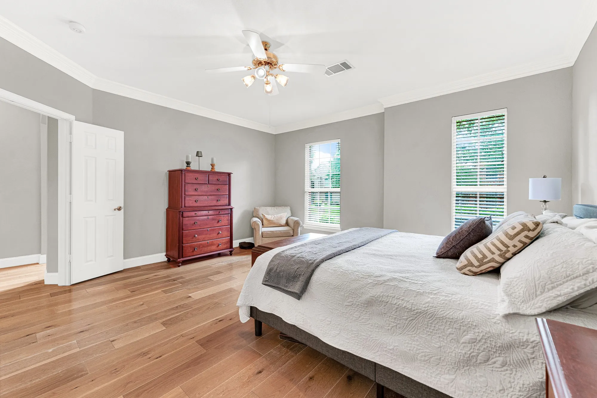 Rich wood flooring anchors the expansive walls, catching the sunlight beautifully. Picture yourself unwinding here after a long day as the afternoon sun recedes.