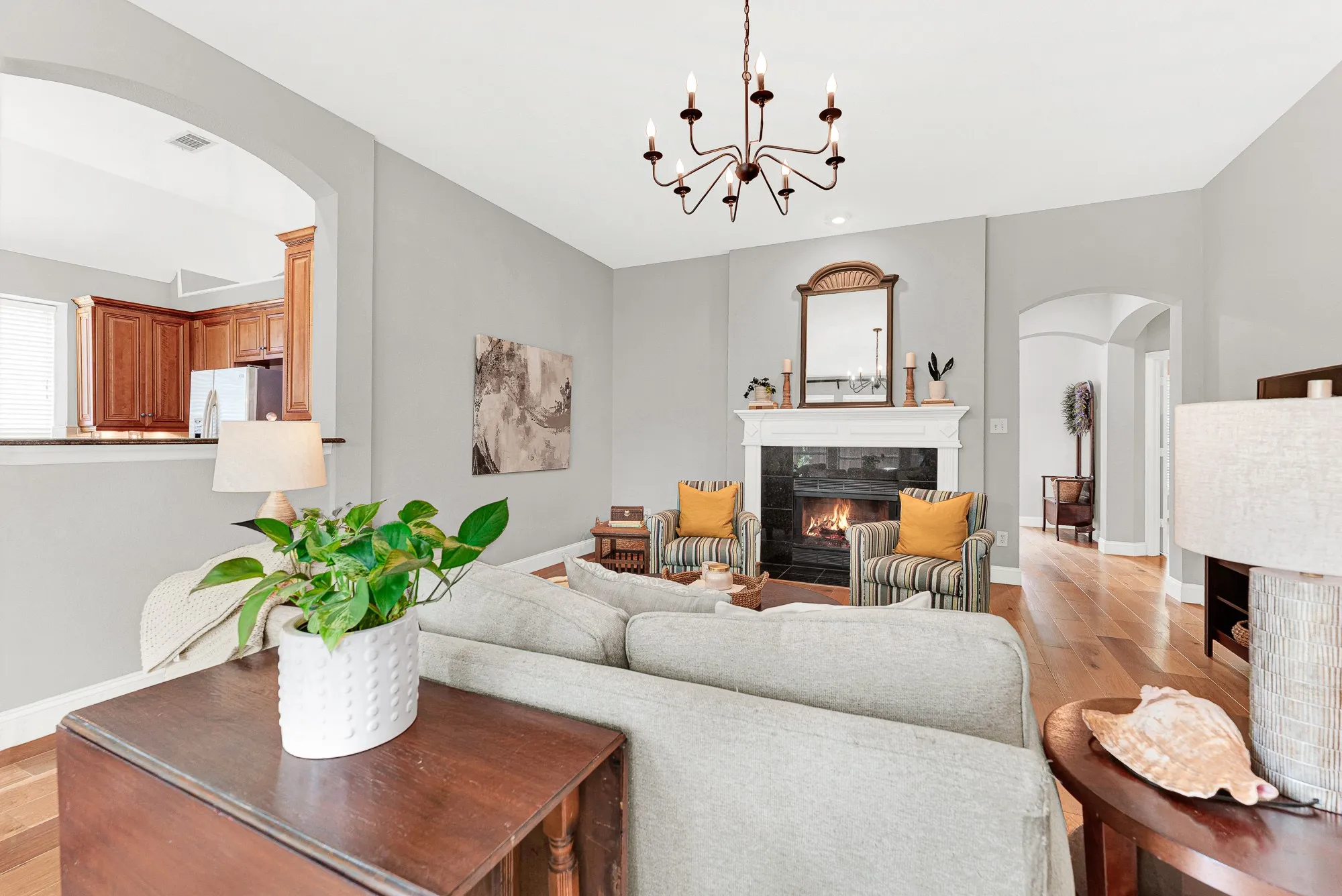 Arched openings on both sides of the family room create a natural flow between the kitchen, hallway, and living spaces, making the entire first floor feel open and connected. This is the room where the whole family lands at the end of the day — and nobody leaves until bedtime