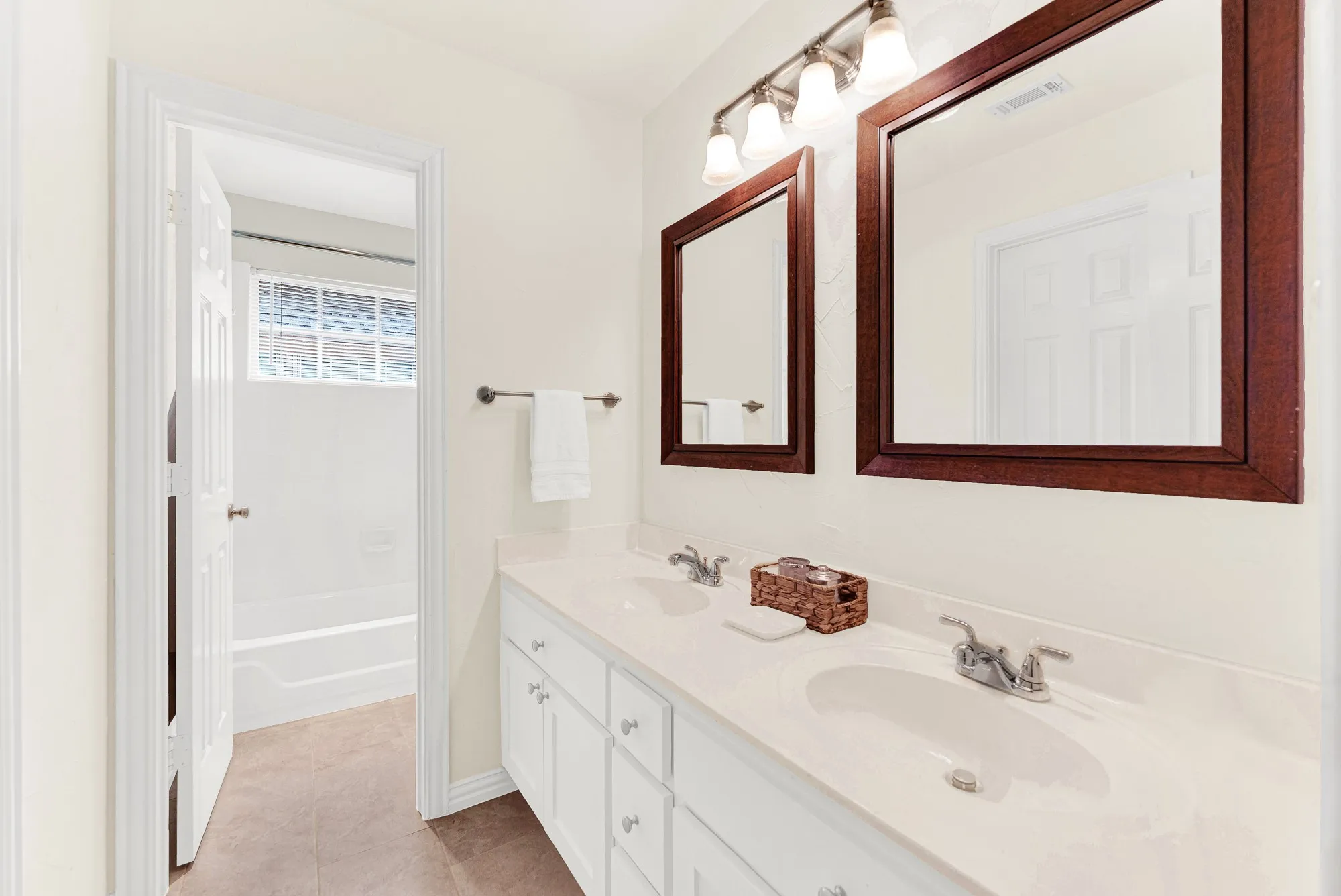 The dual vanity setup maximizes counter space and connects seamlessly to a private, separate shower and bath area. Getting ready for the day becomes effortless when two people have their own designated space.