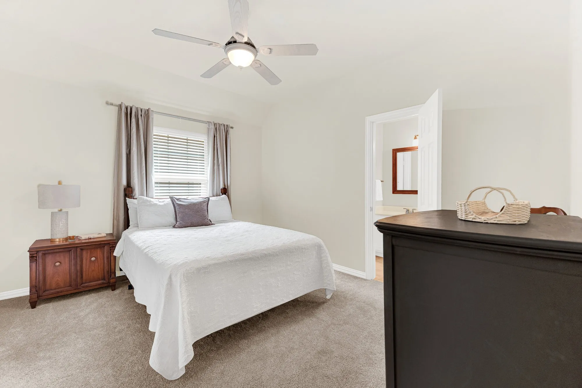 A wide, bright window serves as a beautiful focal point, bathing the entire room in calming natural light. Imagine winding down after a busy afternoon, enjoying the quiet comfort of a space designed for relaxation.