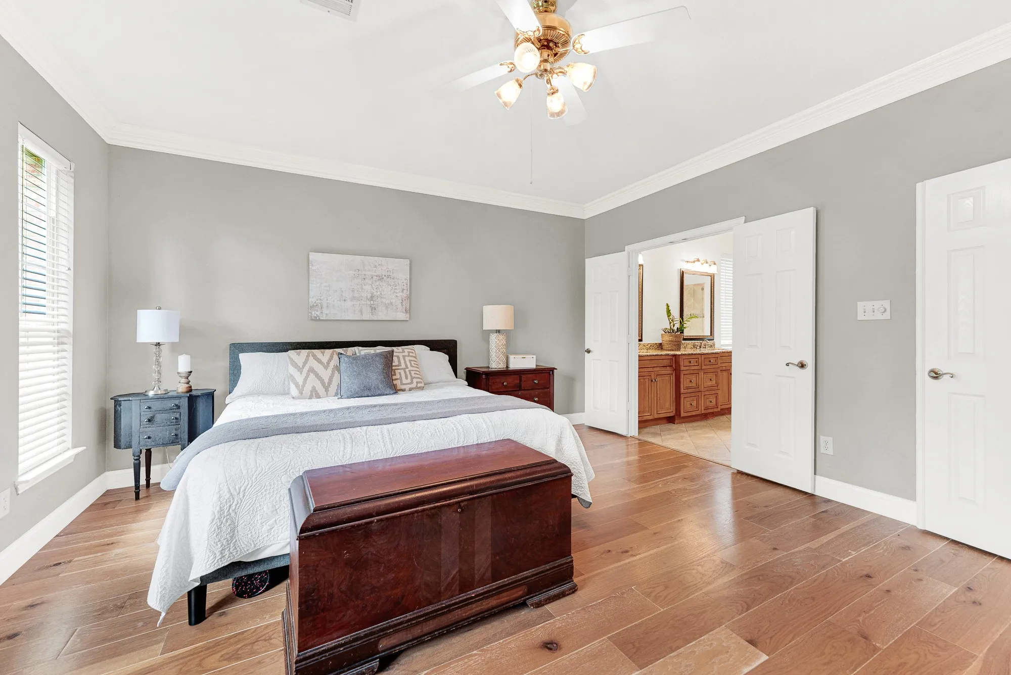 A wide doorway offers a seamless transition into the adjacent bath area. You can easily glance into your bright morning haven right from the bedroom.
