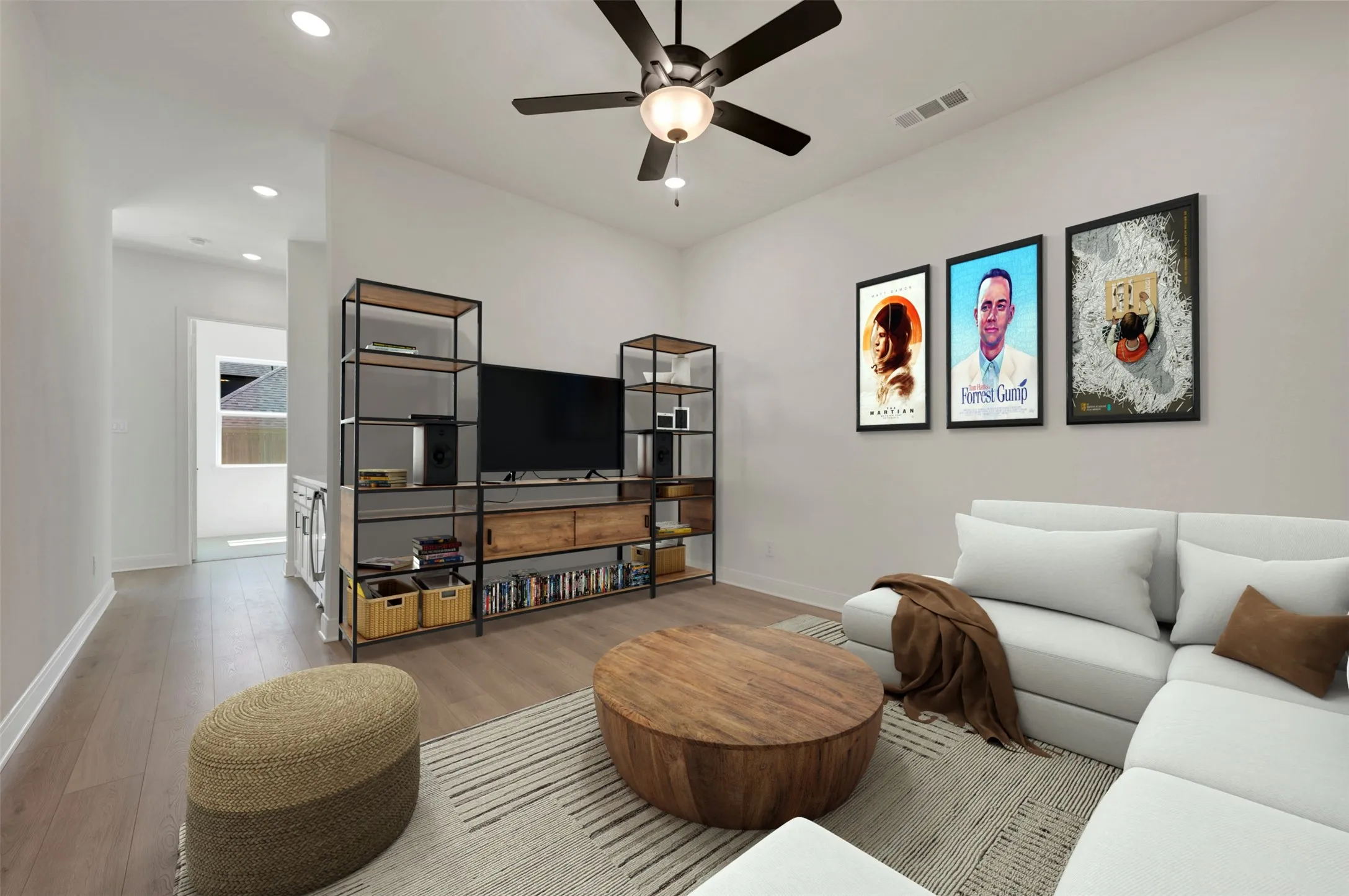 Vaulted ceiling with recessed lighting and a ceiling fan, wood-finish flooring, and a built-in media console with open shelving
