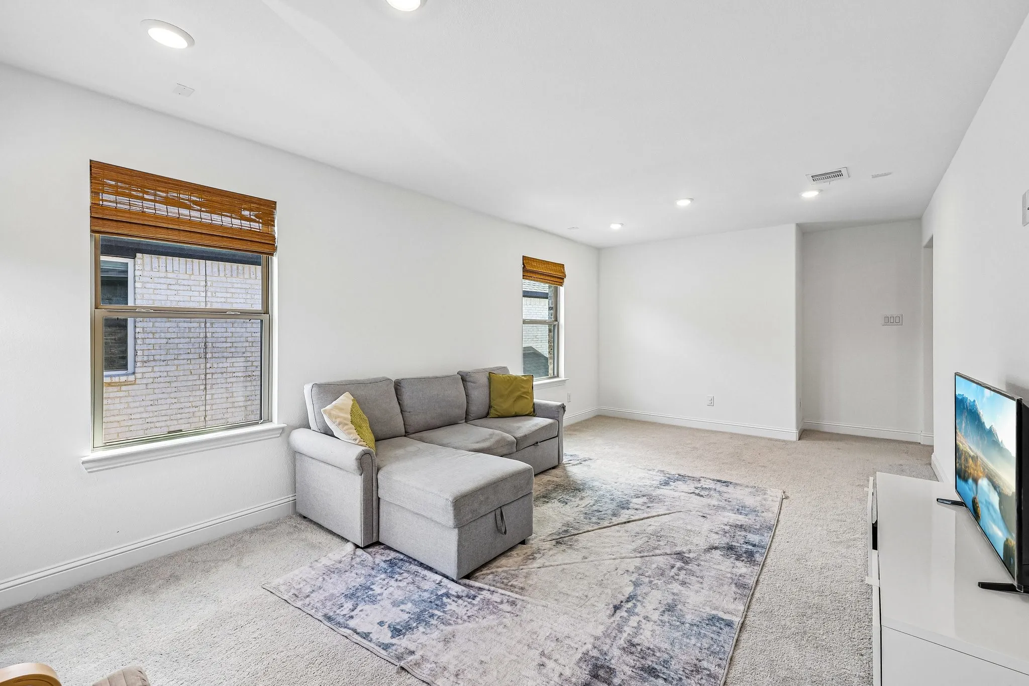 Spacious room with plush carpeting and bright white walls