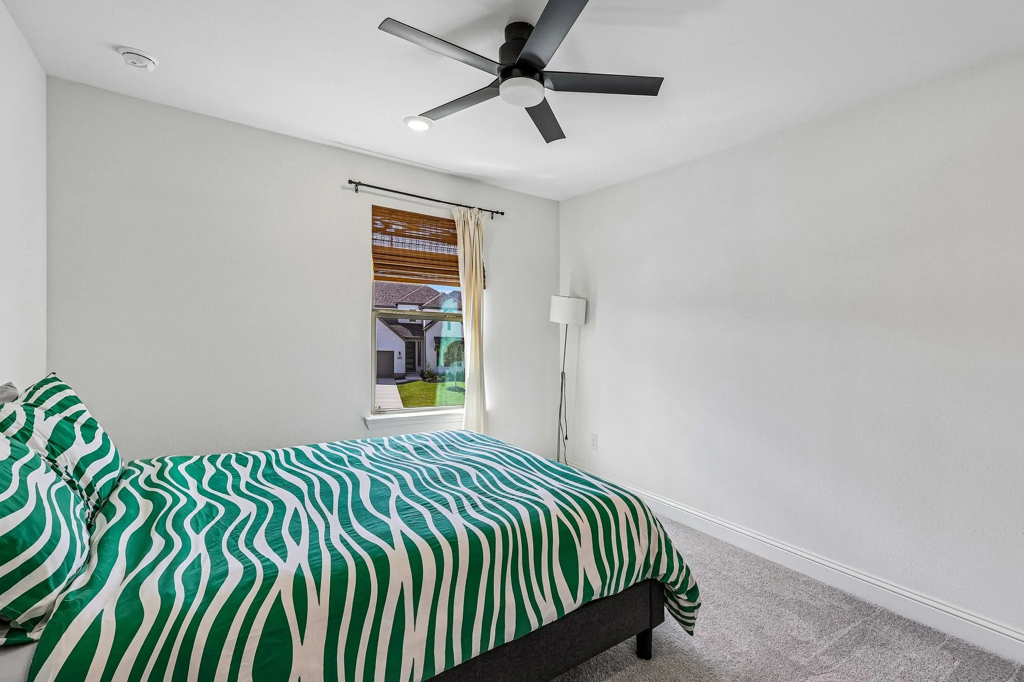 Neutral wall paint with crown molding and grey carpet flooring