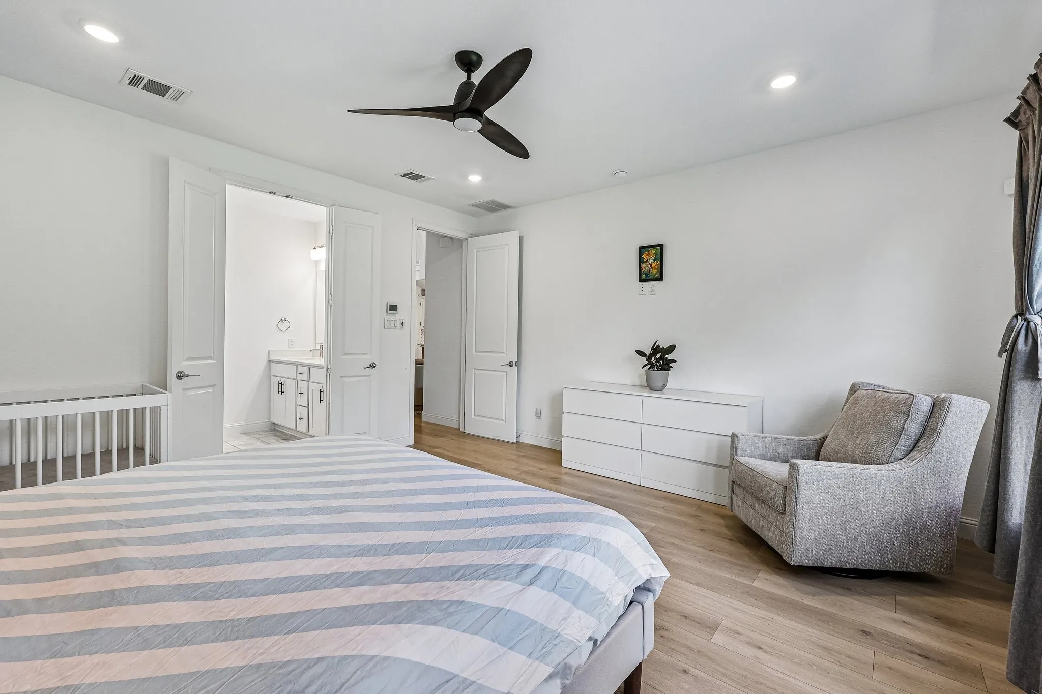 Bedroom featuring wood-finish flooring, recessed lighting, and a contemporary ceiling fan