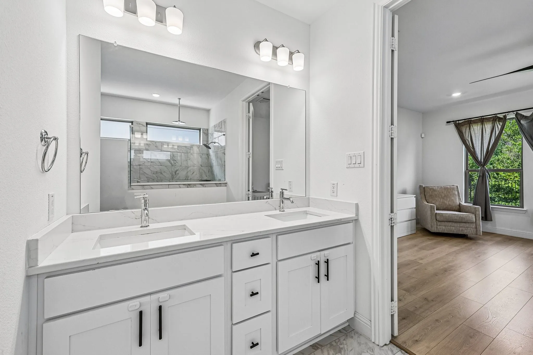 Dual vanity with undermount sinks and light-colored countertops