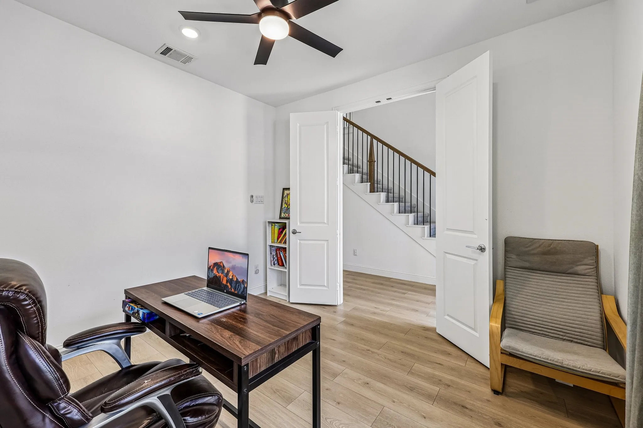 Room featuring light wood-finish flooring and bright white walls