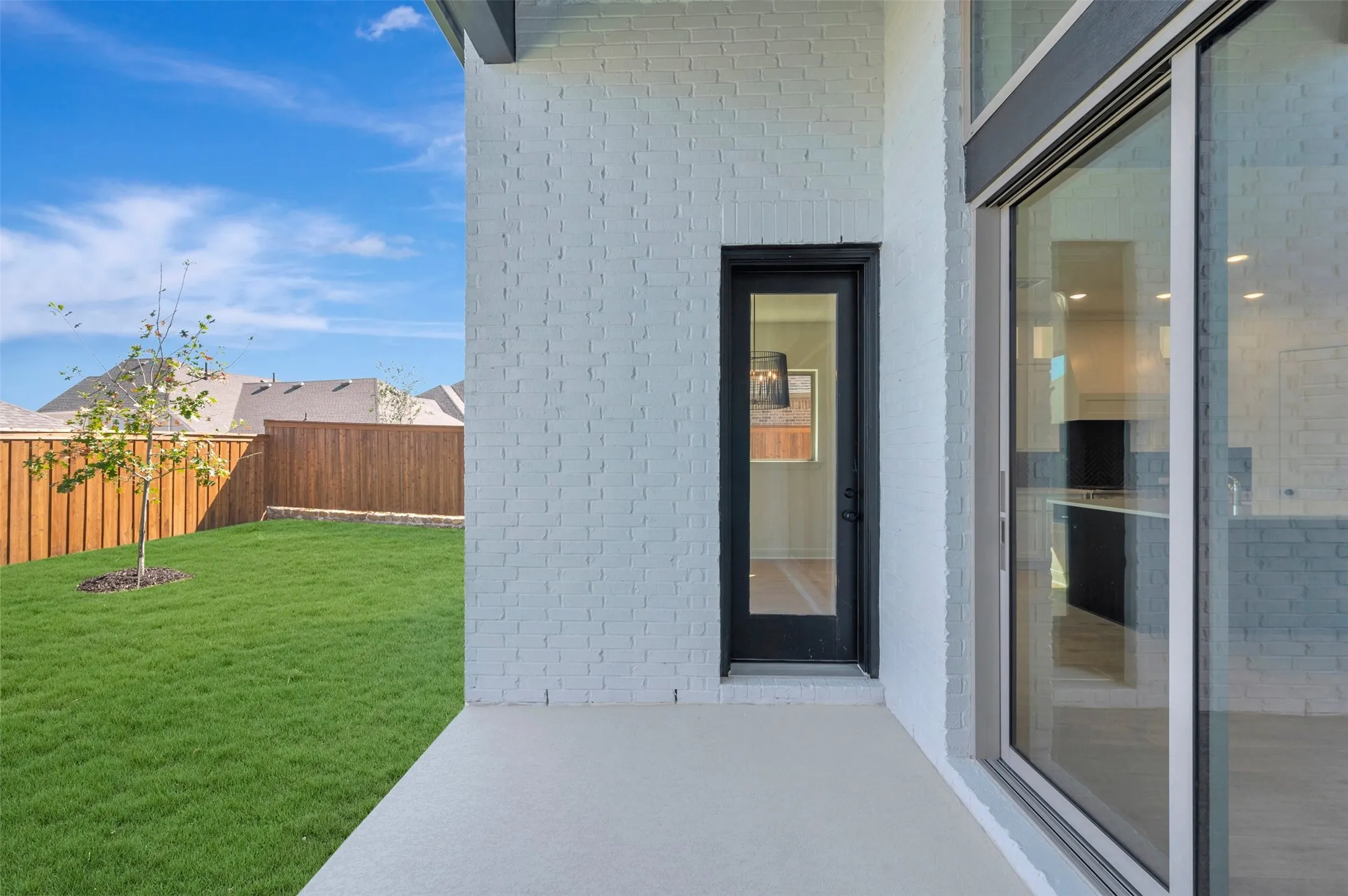 Expansive outdoor patio with direct access to a private backyard