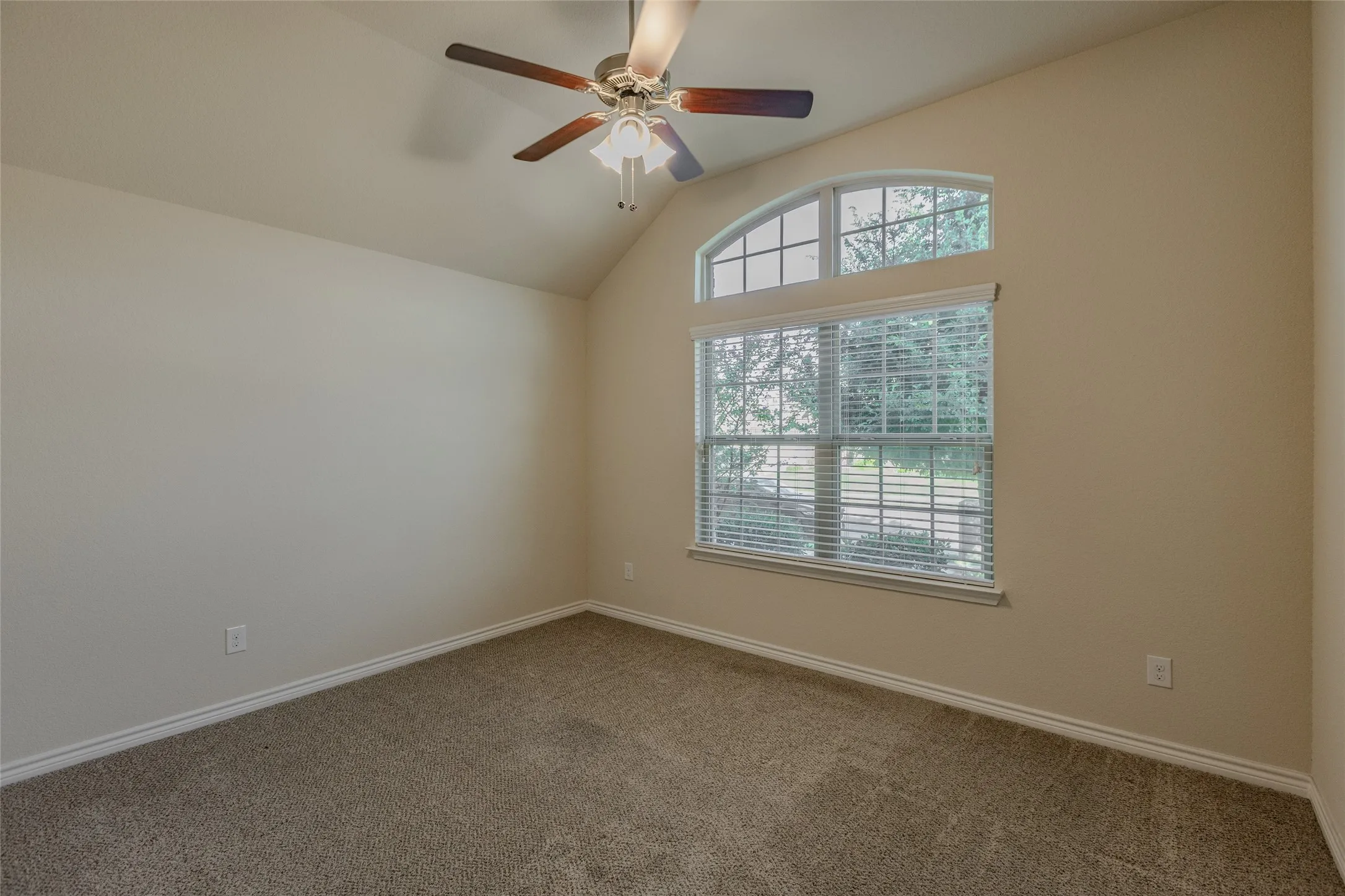 Front bedroom. Vaulted ceiling with an attached ceiling fan and light fixture