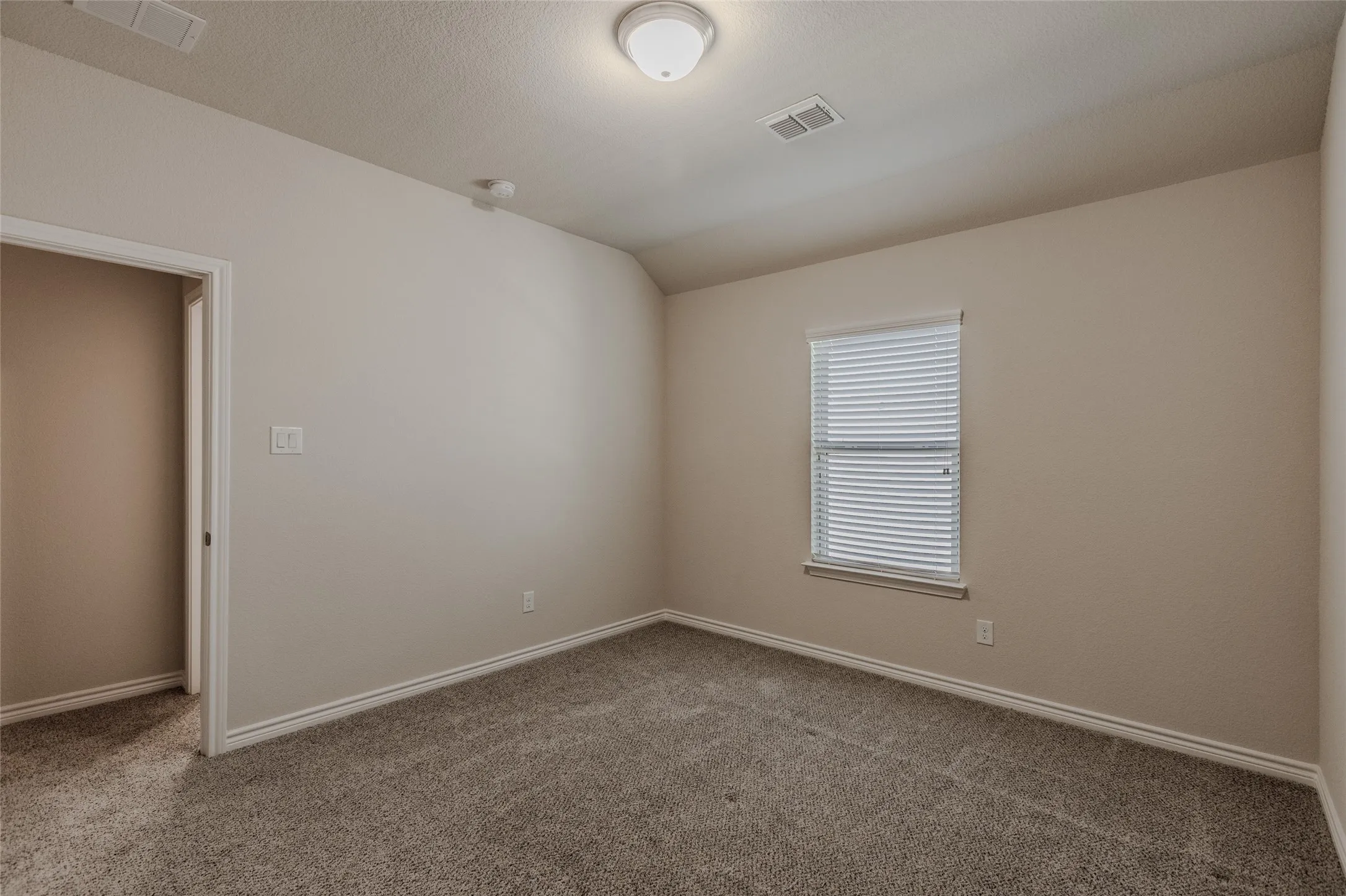 Upstairs bedroom. Neutral-toned walls complement plush carpeting and white trim work