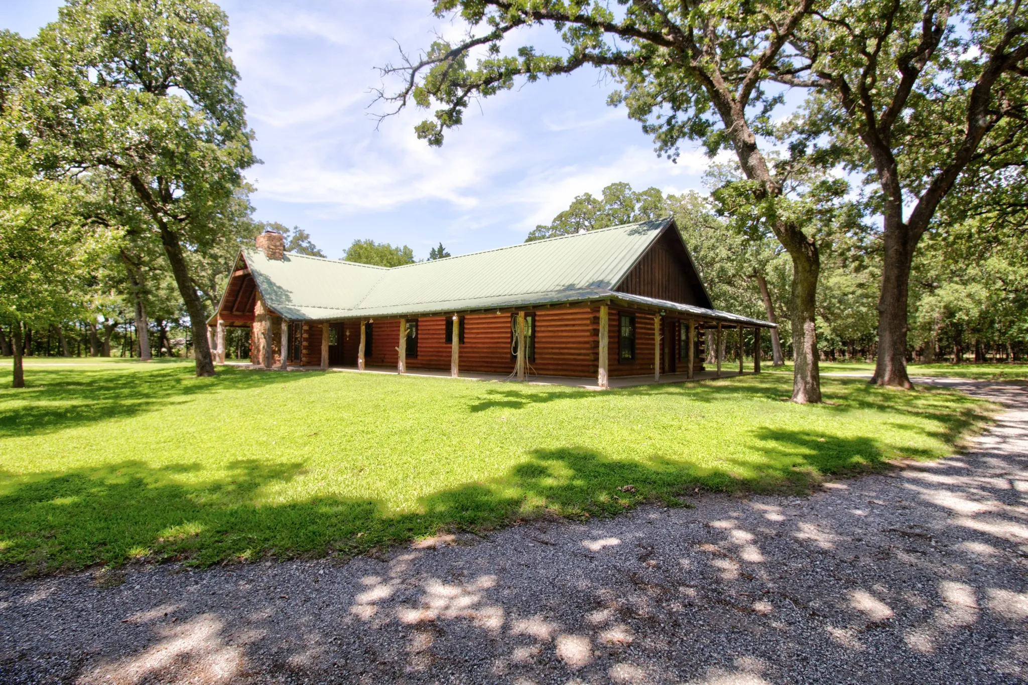 Beautiful view of the Log home, with expansive wrap around porch!