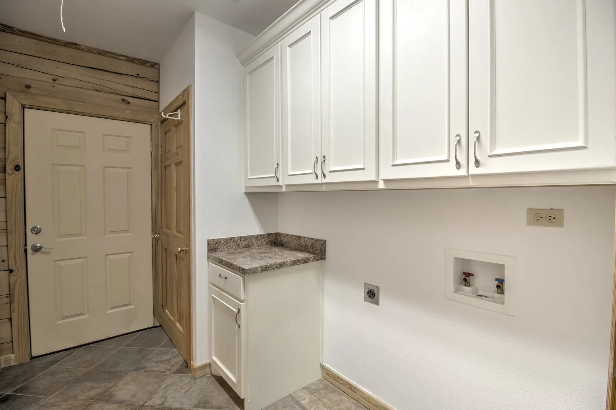 Spacious Laundry room with built in cabinets!