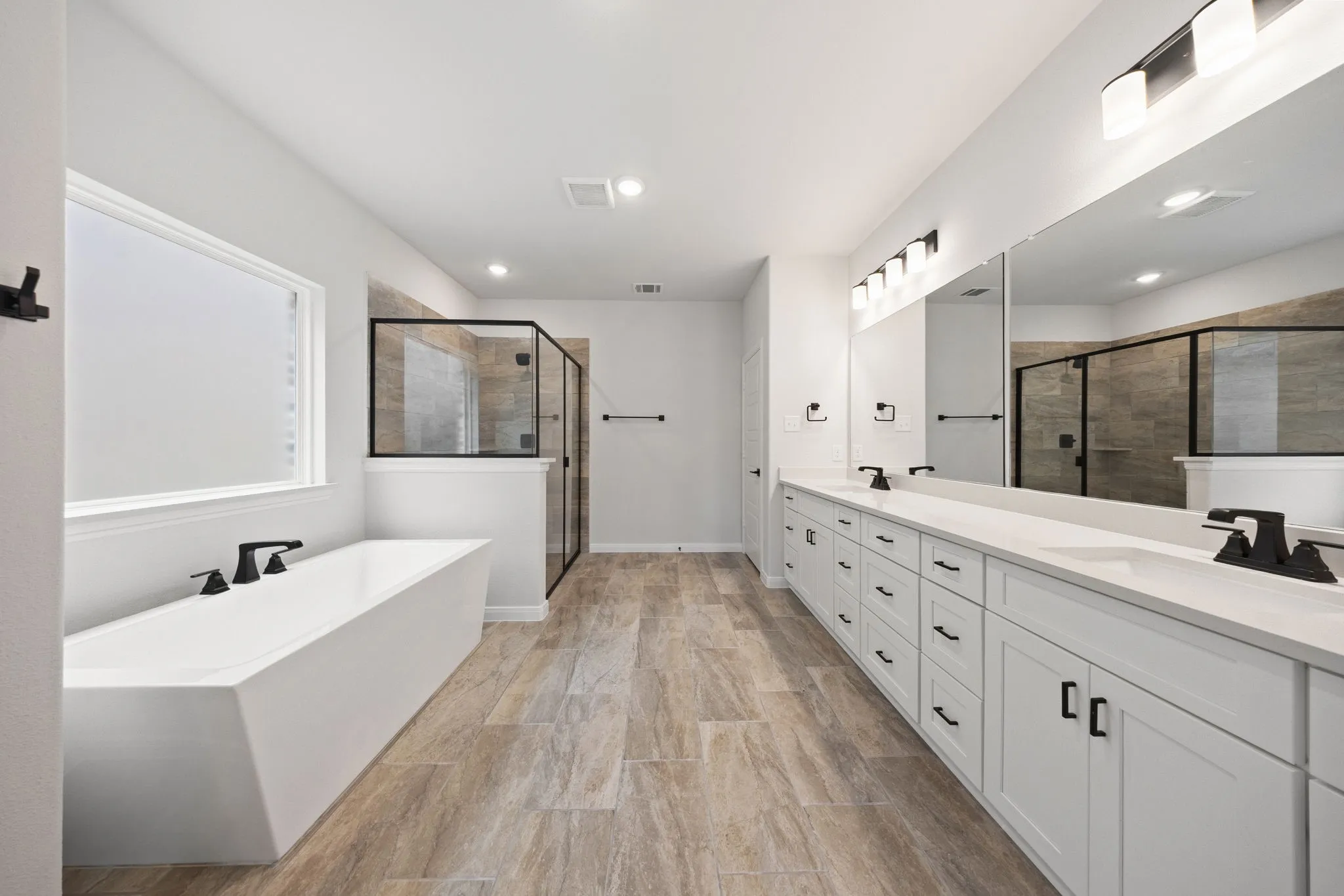 With dual vanities plus ample storage & countertop space, this owner's bath was designed for two!
