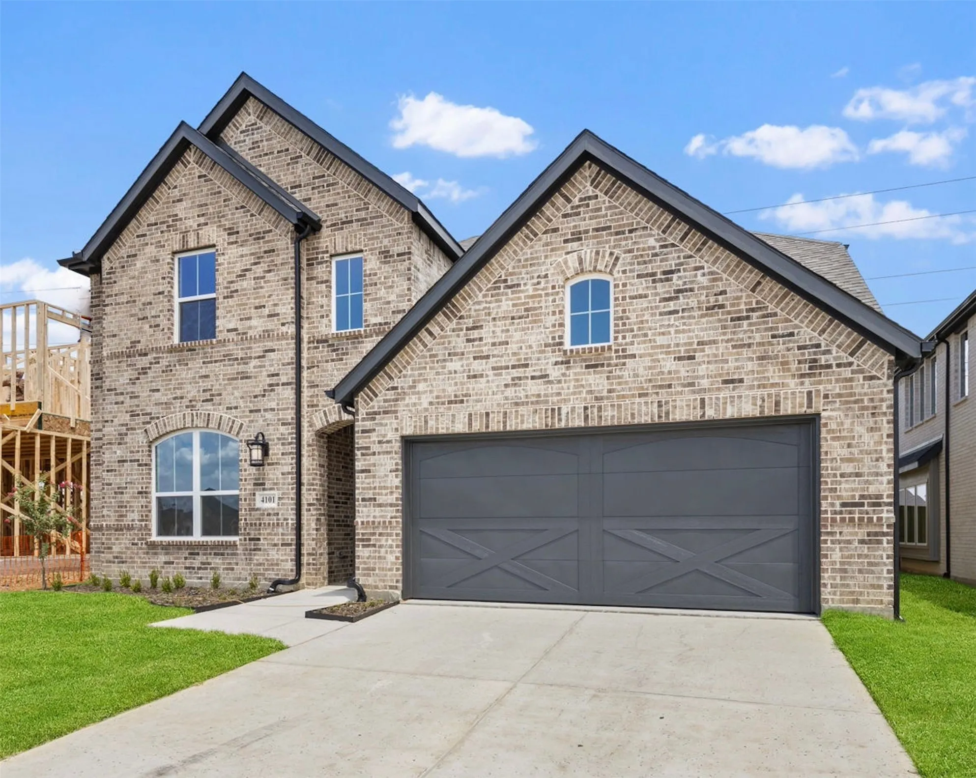 Featuring a neutral color brick exterior accented with striking dark trim and lovely gables, this dream home offers outstanding curb appeal!