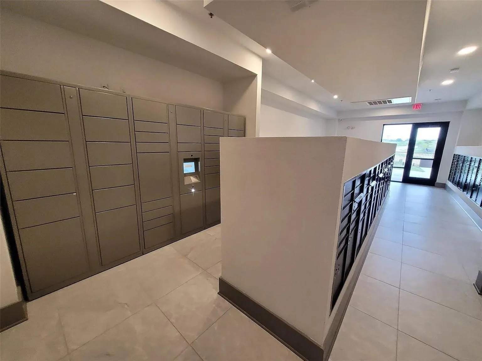 Dedicated parcel lockers and individual mailboxes within a brightly lit communal area