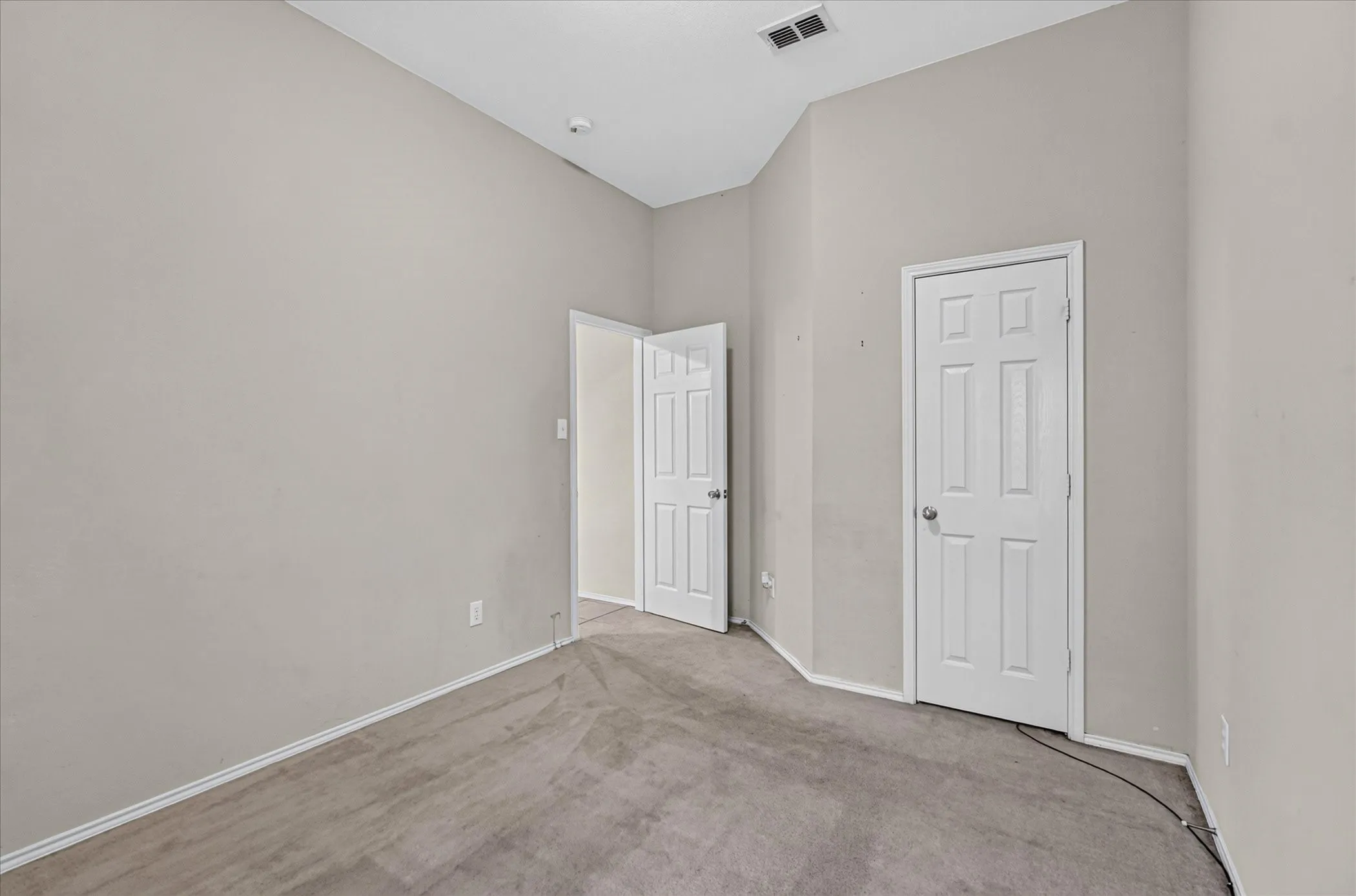 Neutral tone walls with vaulted ceilings