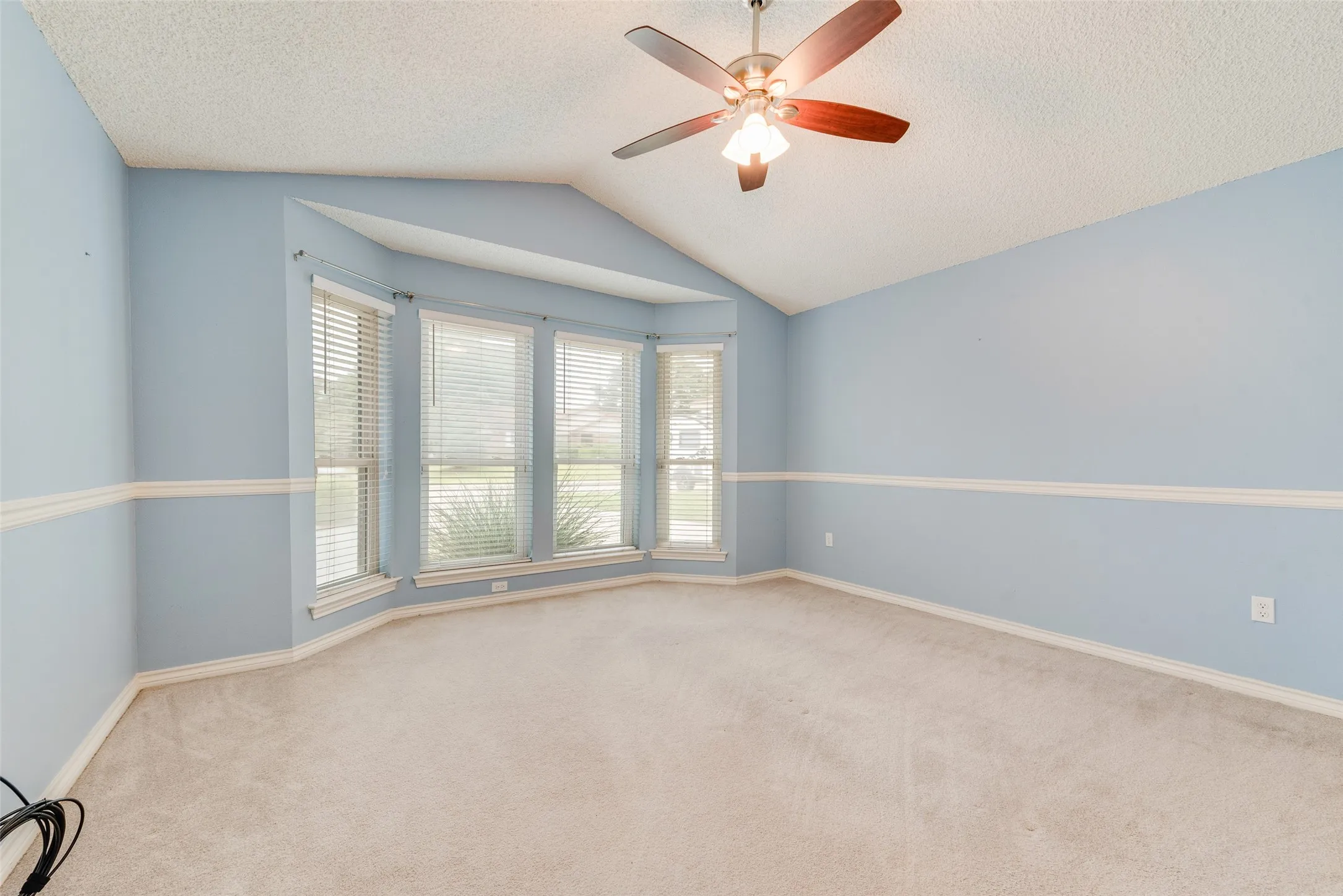 Primary bedroom featuring bay windows