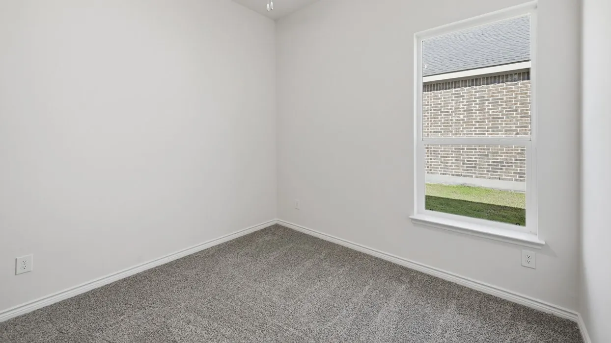 Neutral wall paint, gray carpet flooring, white trim, and a single-pane window
