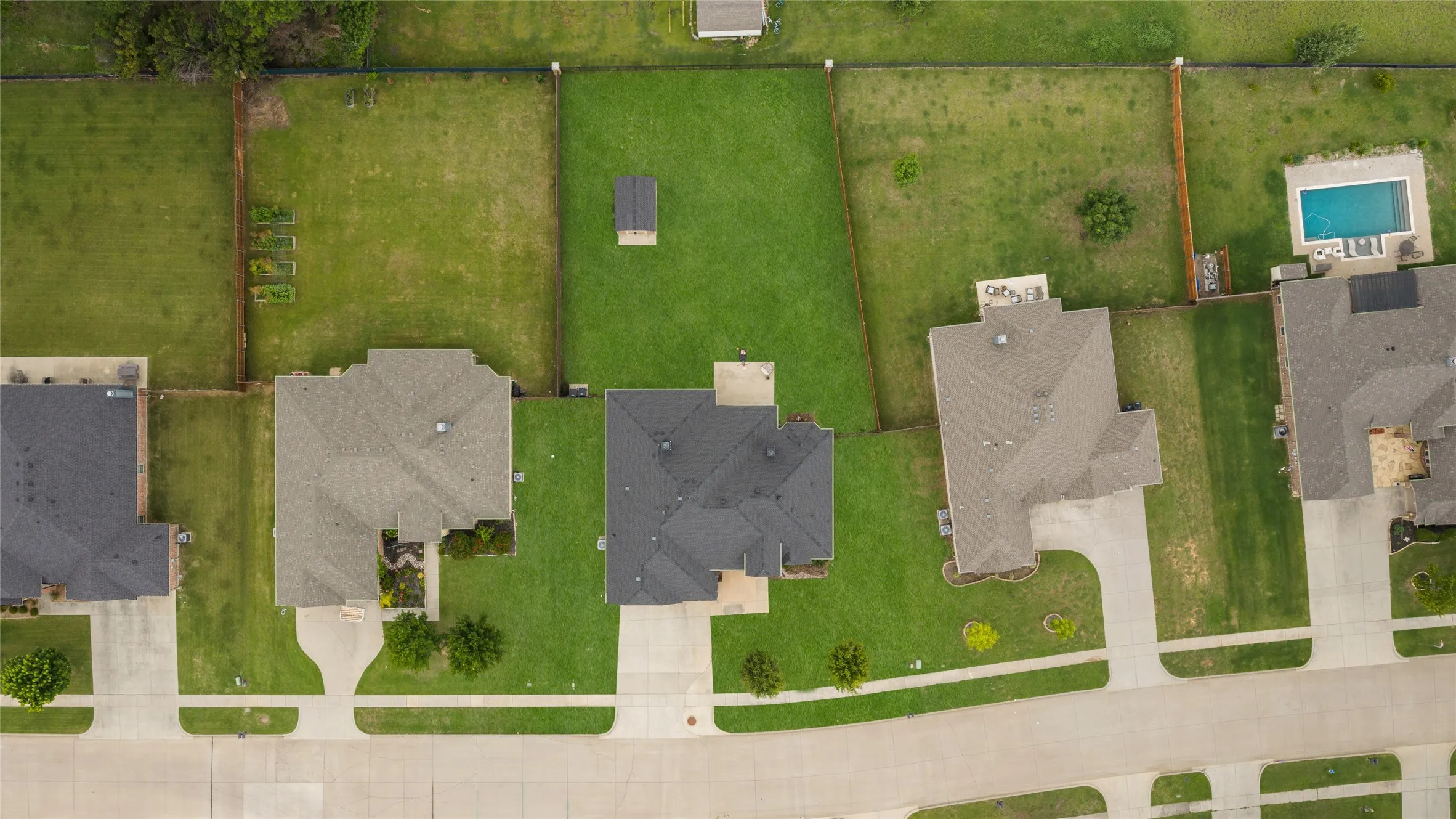 Expansive lot with a sizable backyard, mature landscaping, and an attached two-car driveway
