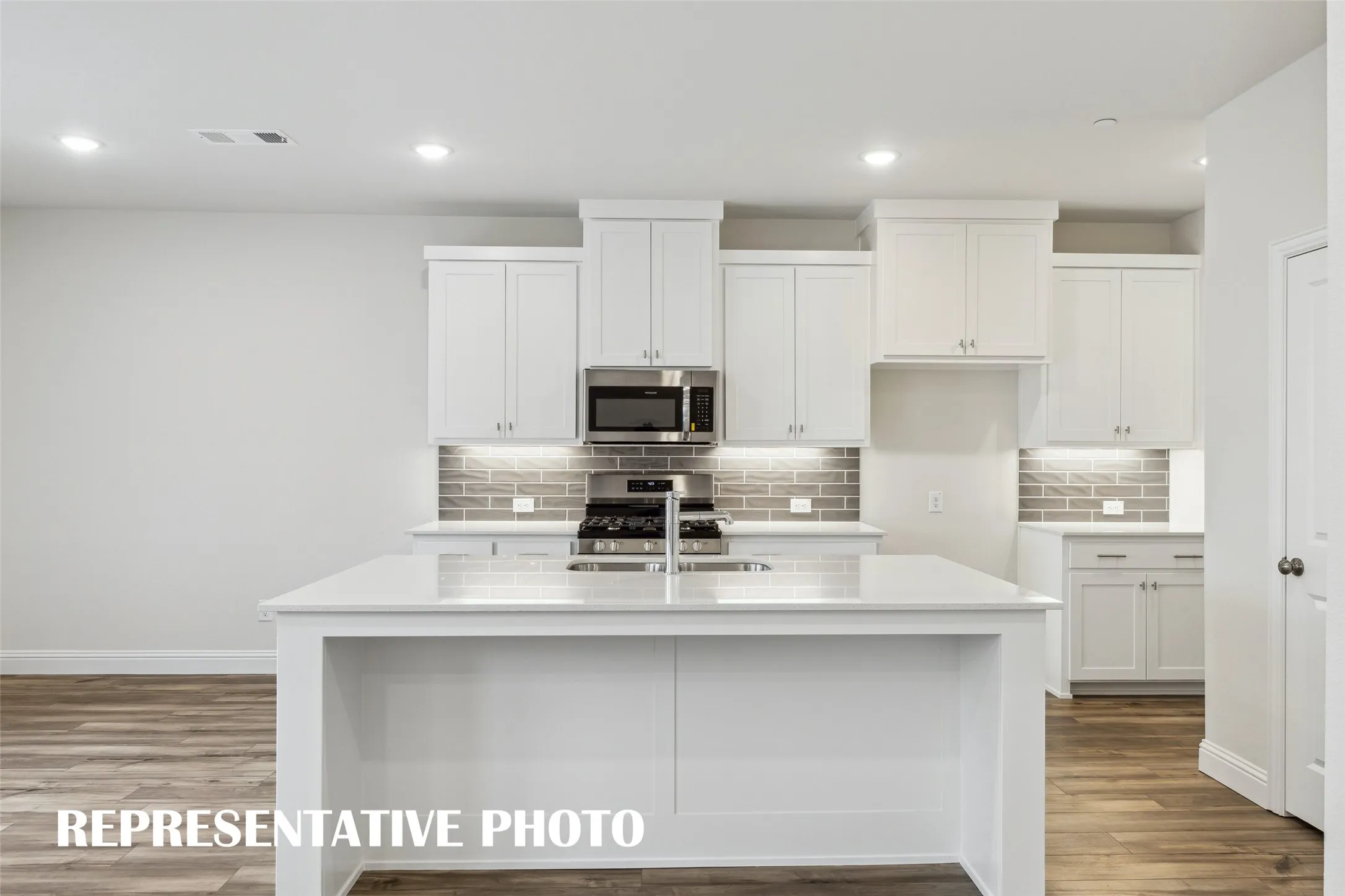 The spacious island is the hub of your new kitchen and the perfect place for friends and family to gather round!  REPRESENTATIVE PHOTO