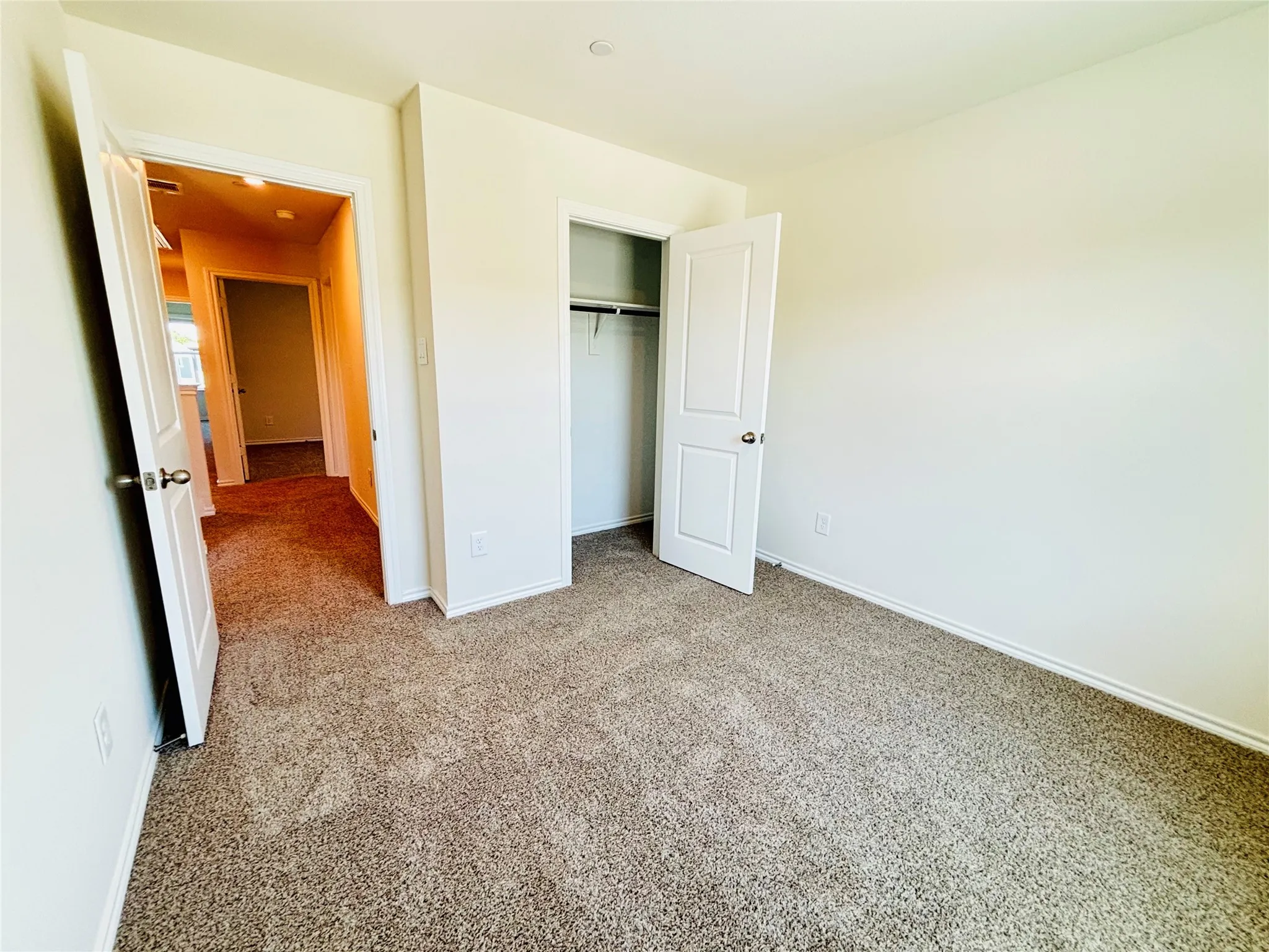 Bedroom featuring neutral tone carpeting and light-colored walls