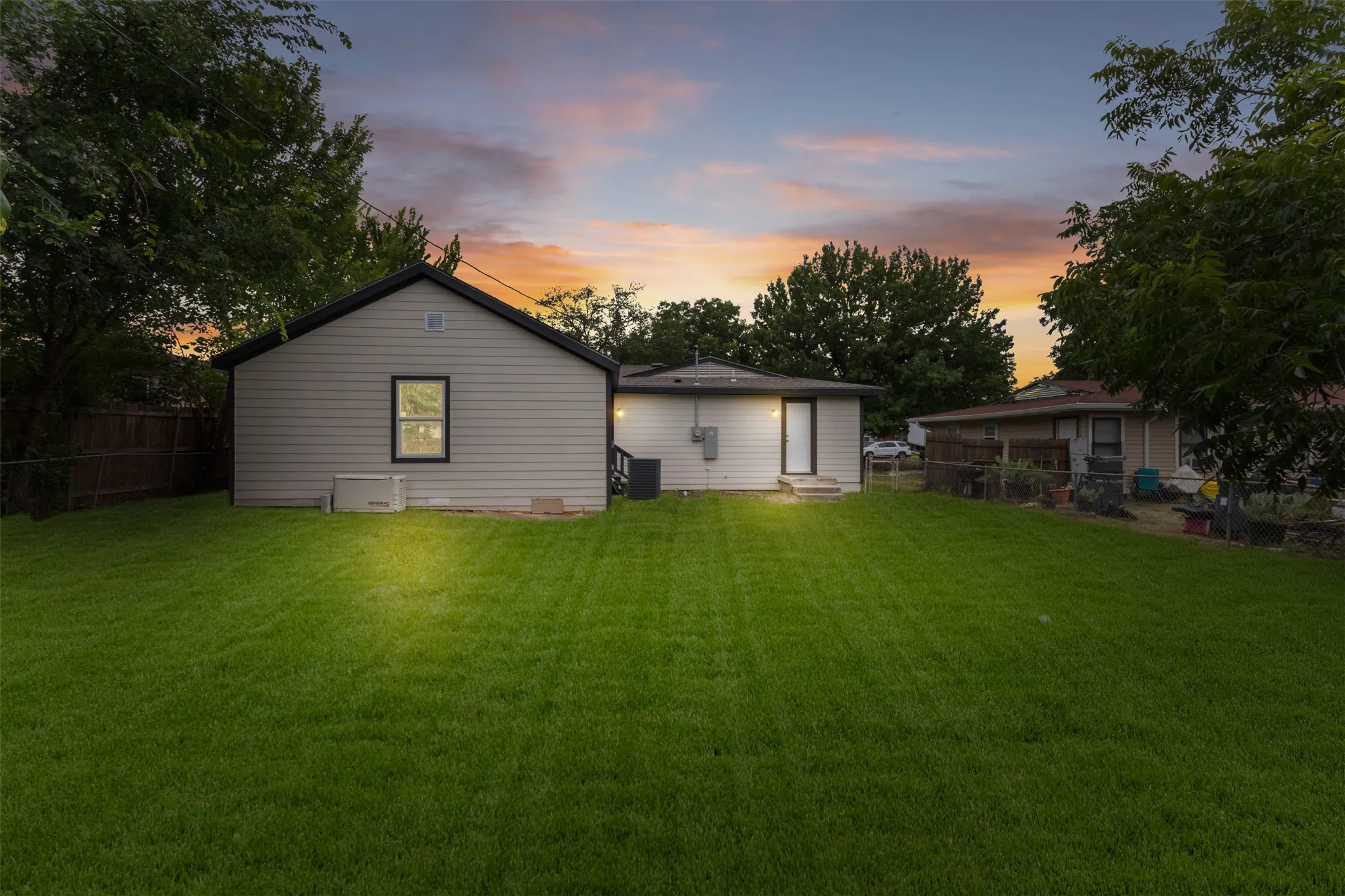 Expansive green lawn with mature trees, offering ample outdoor space