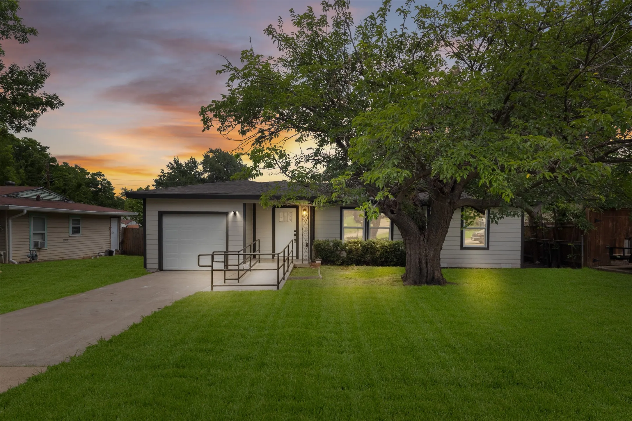 Single-story residence featuring light-colored siding and a dark roofline