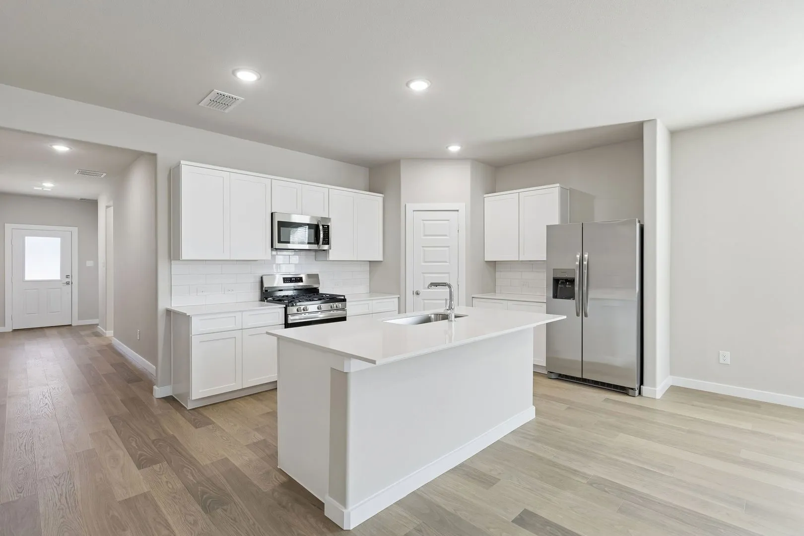 Kitchen in the Holden home plan by Trophy Signature Homes – REPRESENTATIVE PHOTO