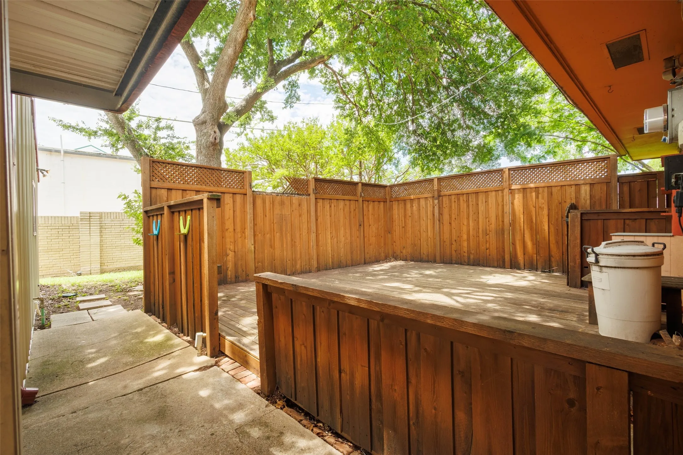 Private outdoor deck featuring wood lattice accents, and perimeter fencing