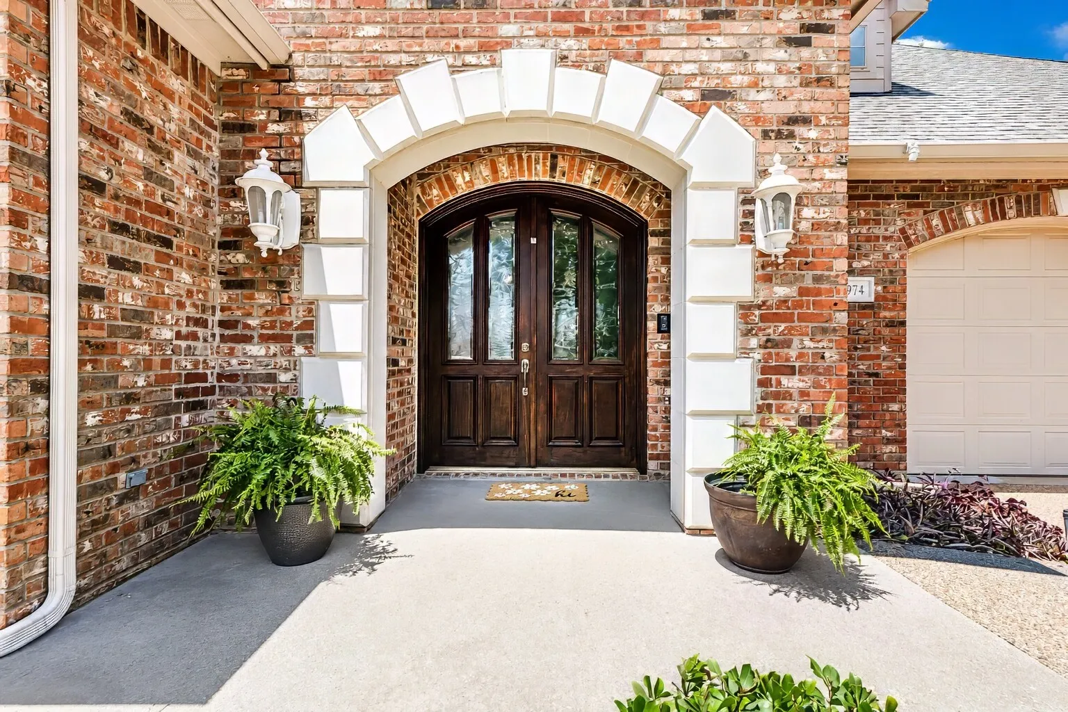 Grand entry and wood doors with etched glass.