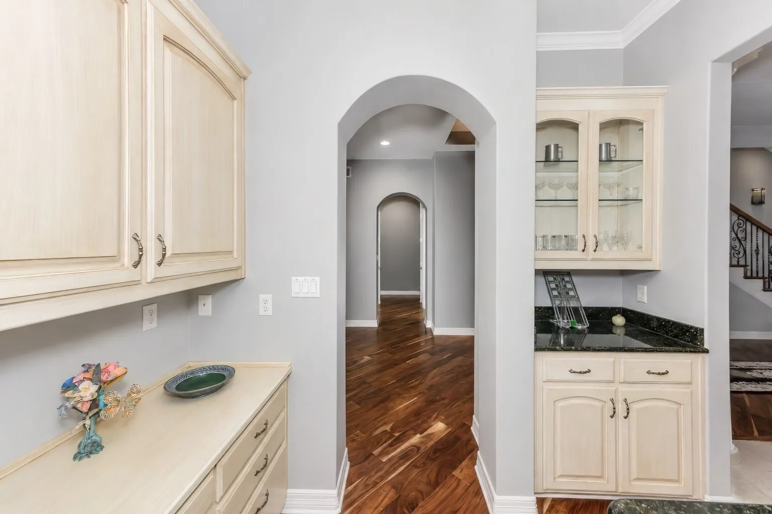 View of dry bar and built in desk by formal dining area